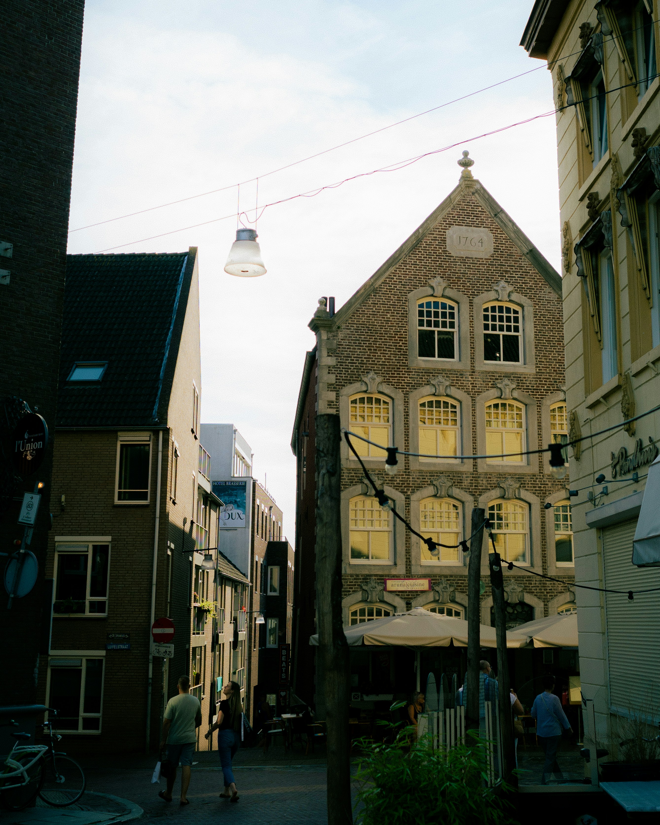 A narrow european street framed by buildings.