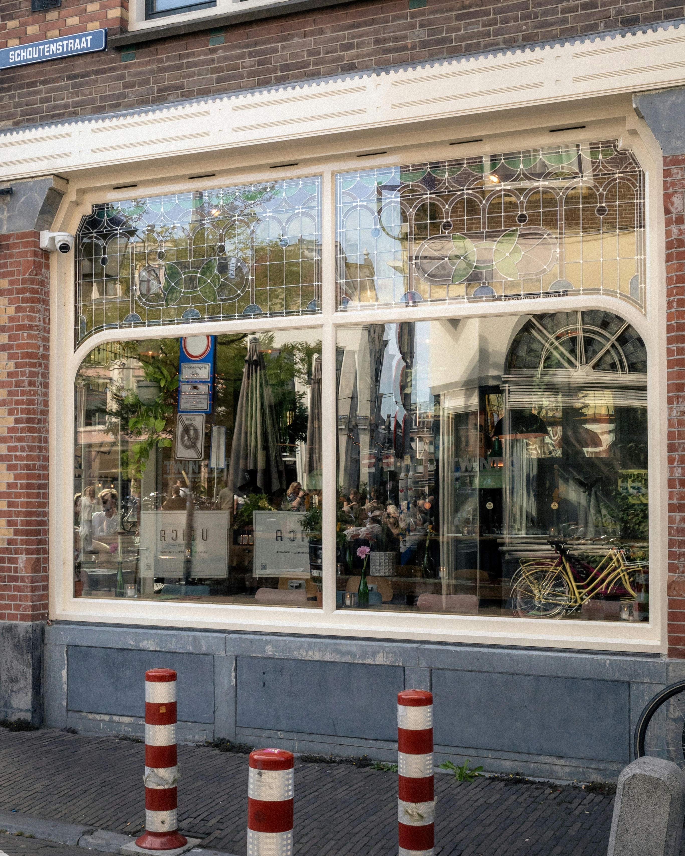 A storefront with large windows and decorations.