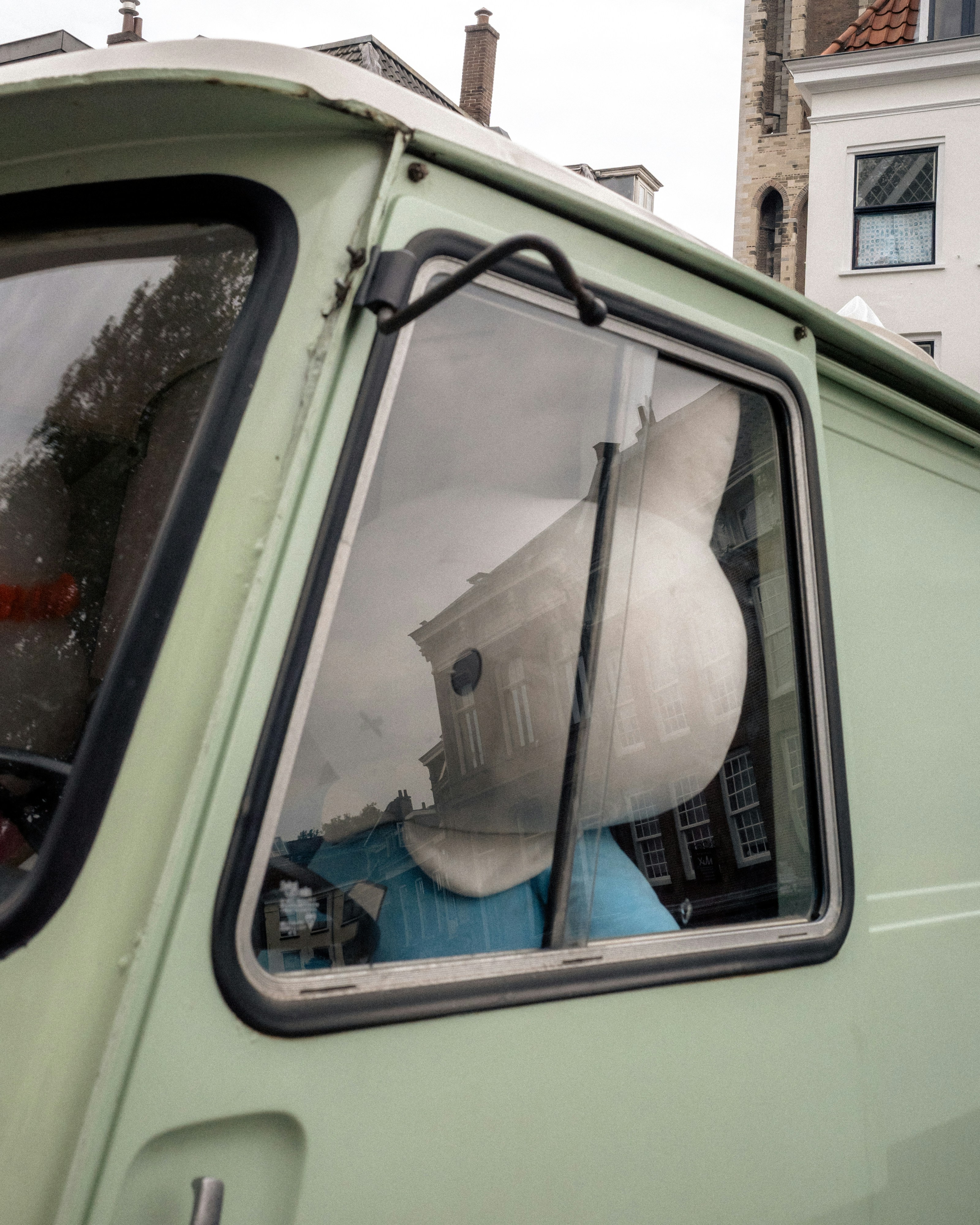 A reflection of a building in a truck window.