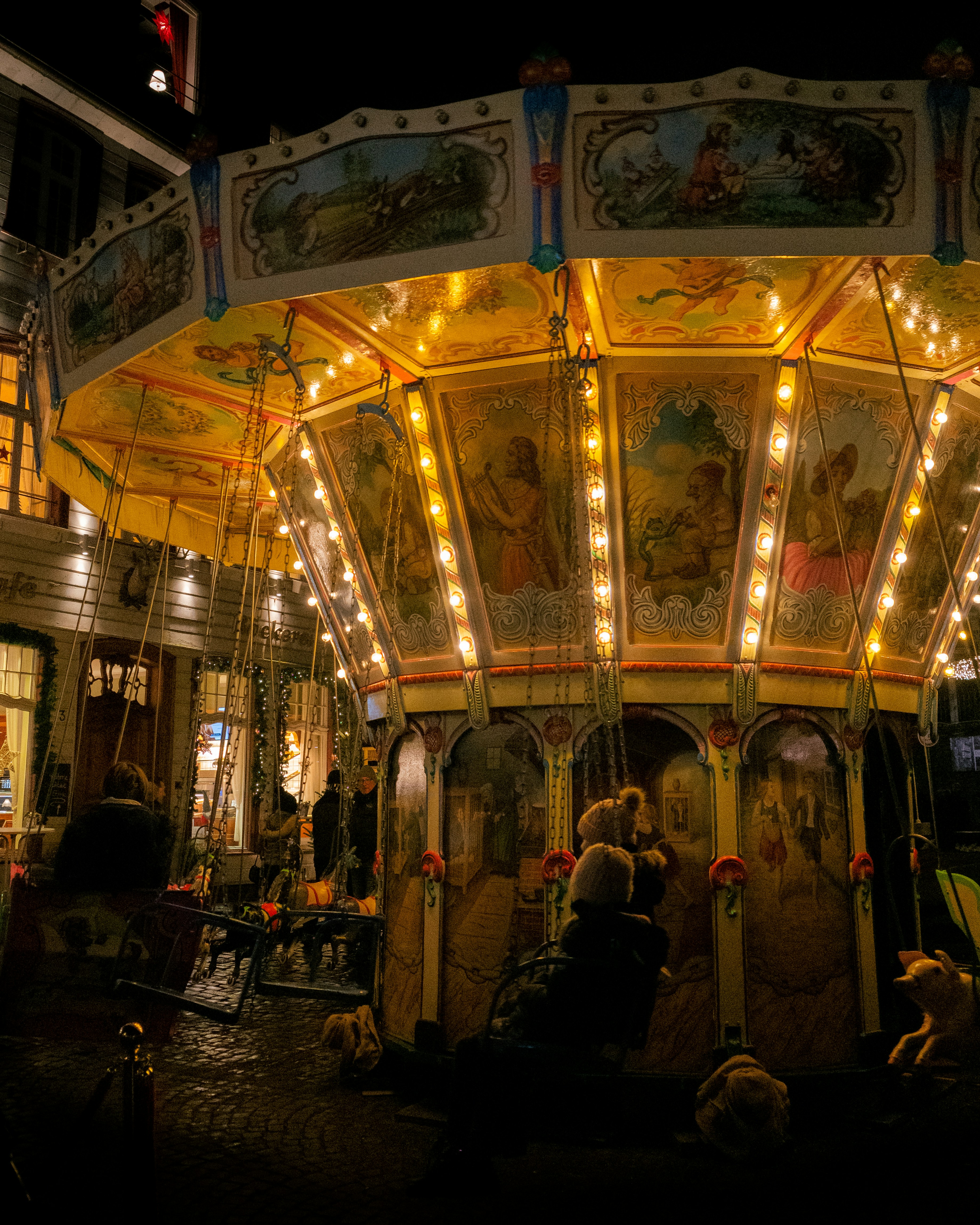 A brightly lit carousel at night is showcased.