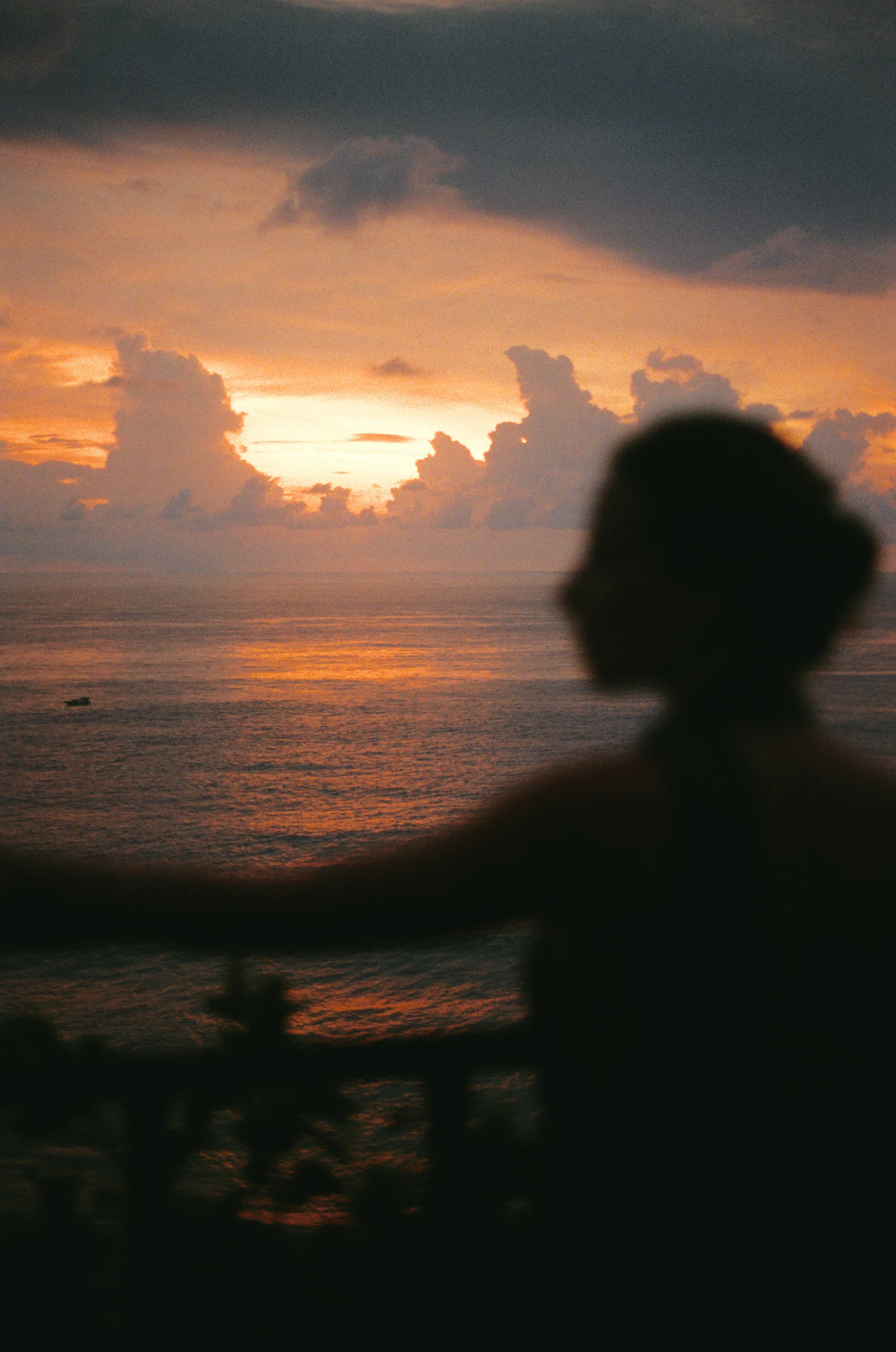 A silhouette against the ocean at sunset