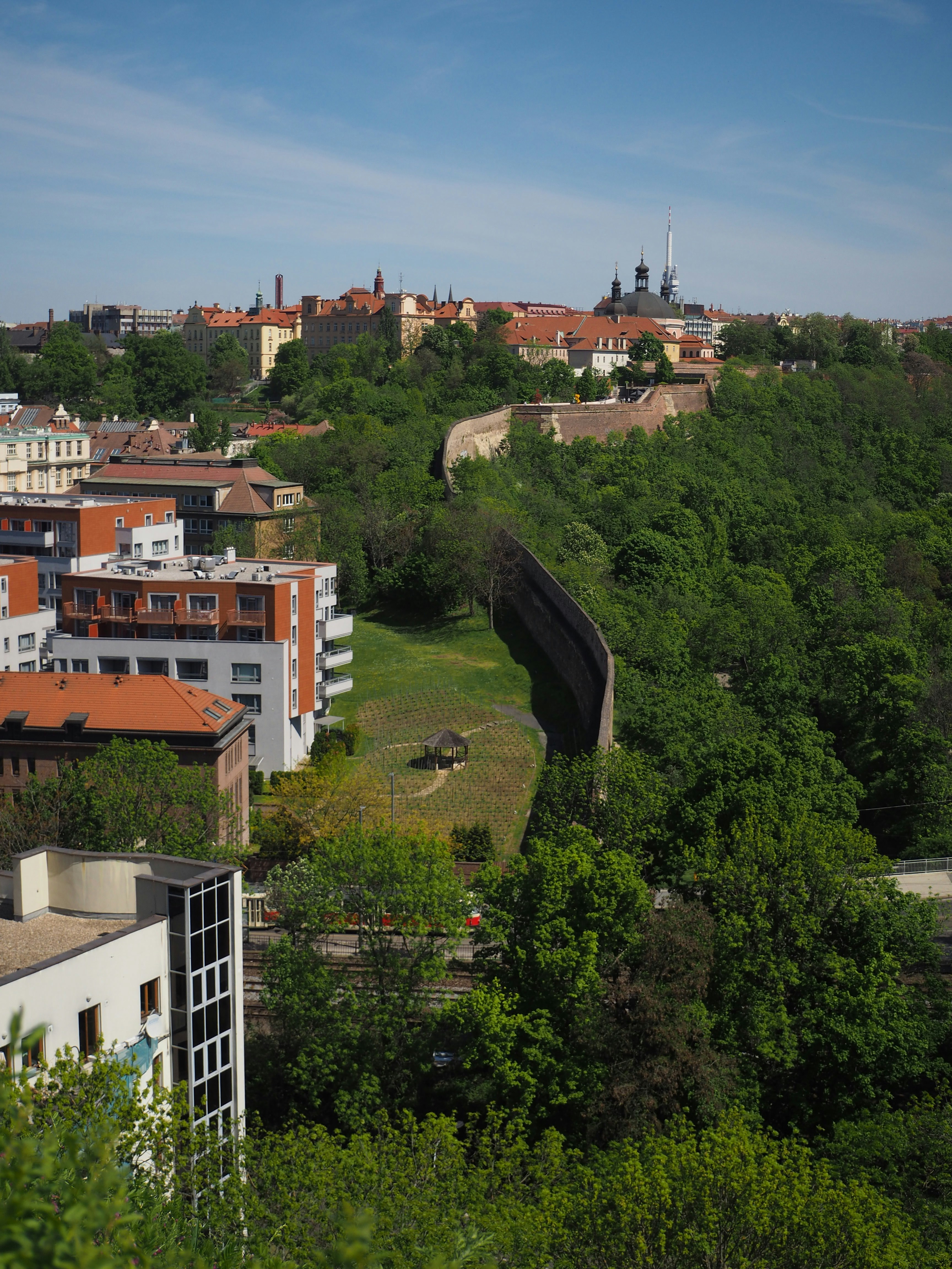 A city wall winds through a lush, green landscape.
