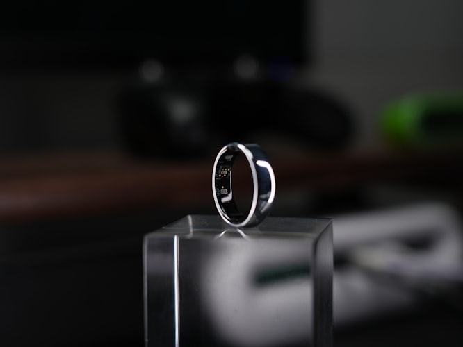 Smart ring on finger showing health data