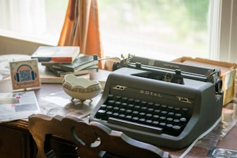 An antique typewriter sits on a desk.