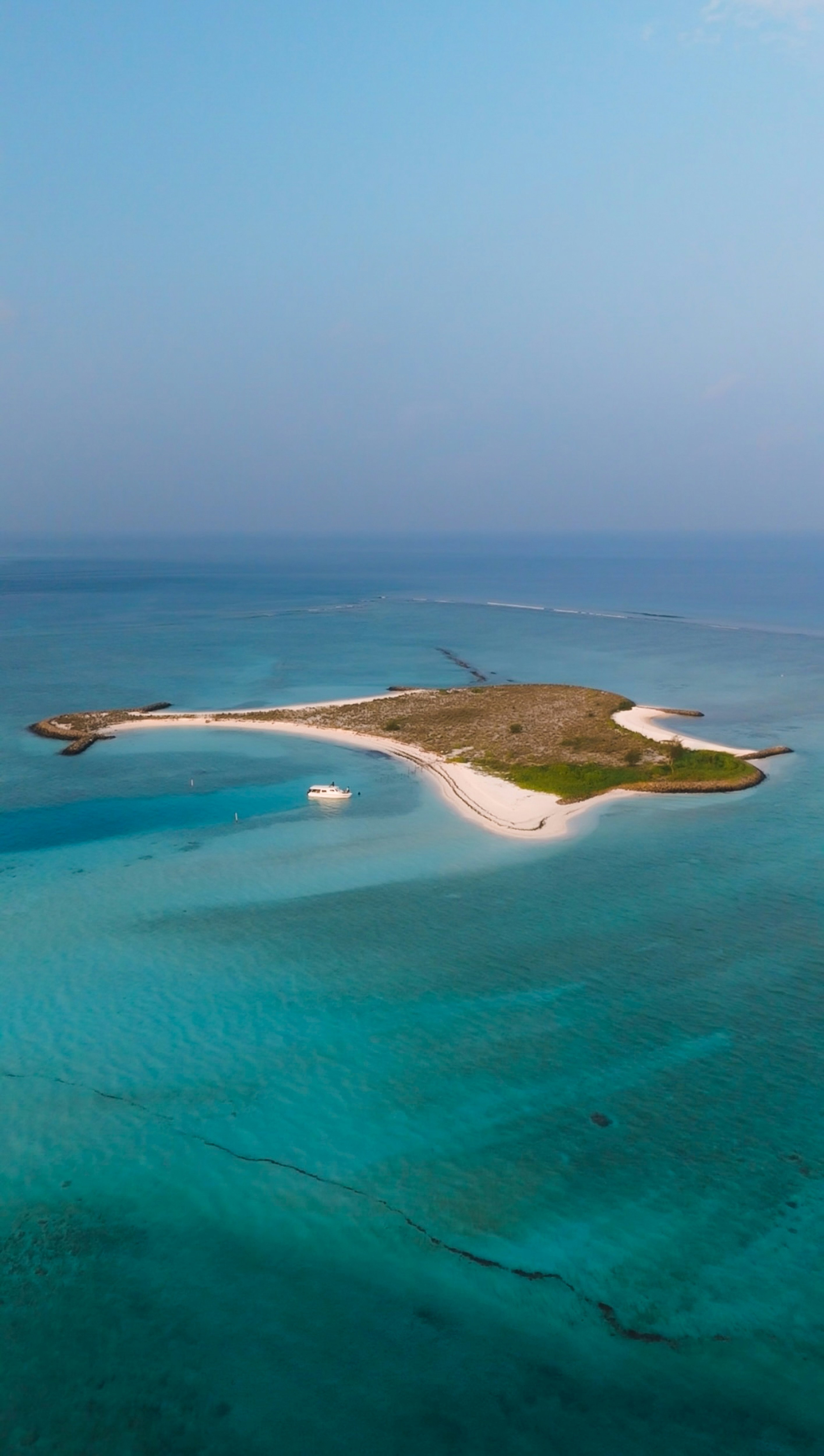 A tiny island amidst turquoise waters.