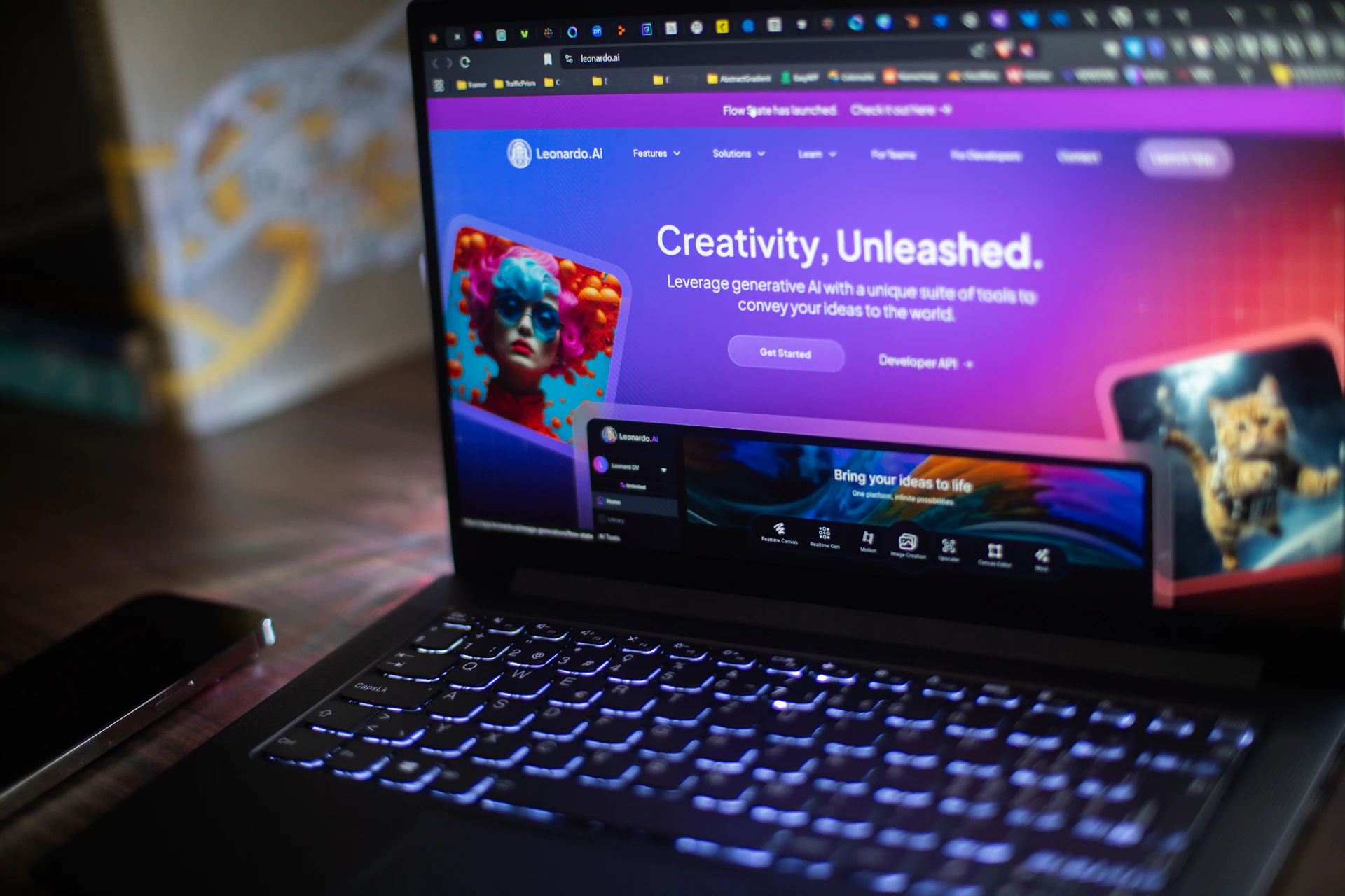 A laptop shows a website about ai creativity.
