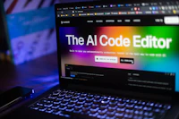 Laptop displays "the ai code editor" website.