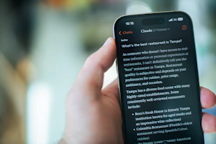 A person reads restaurant recommendations on their phone.