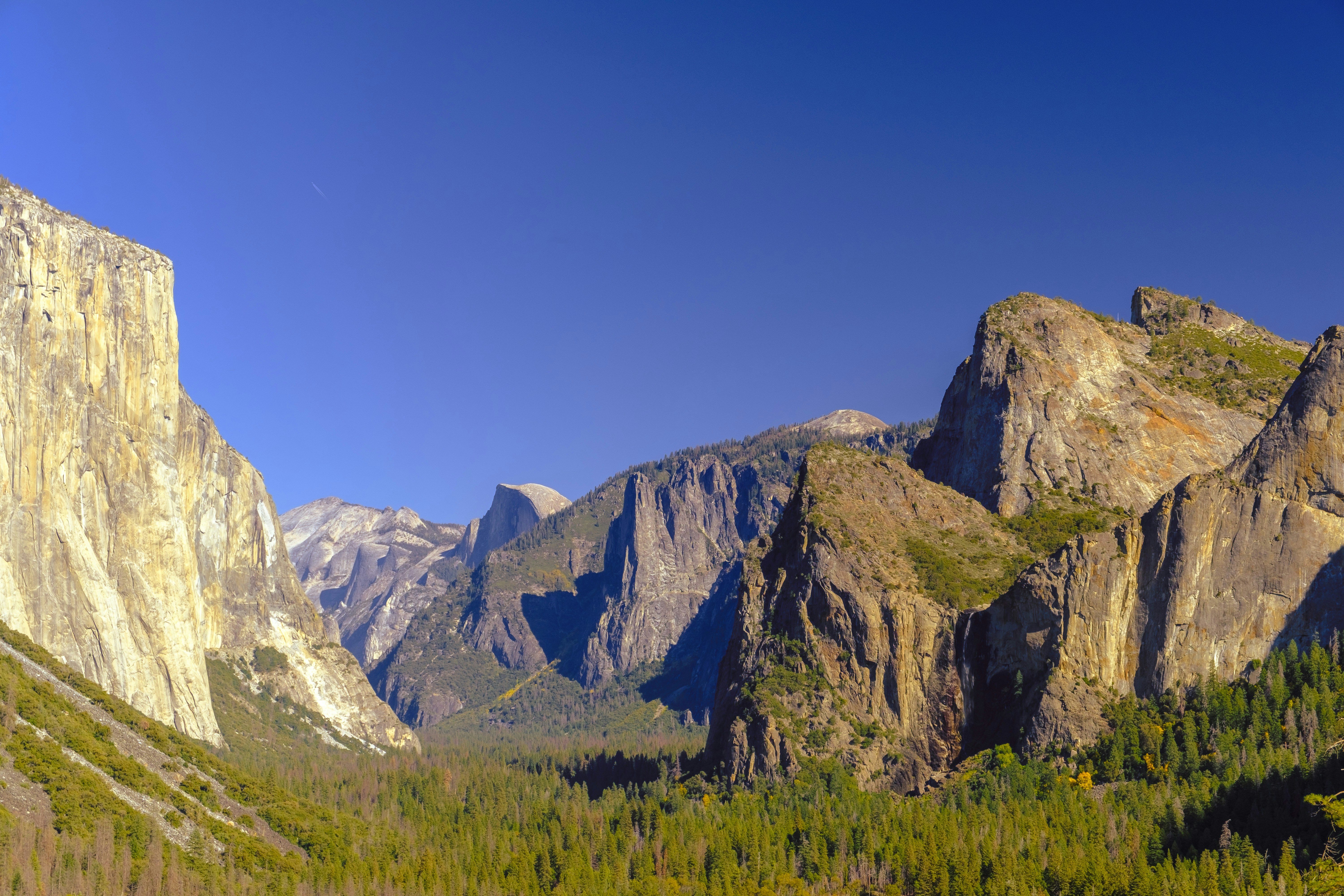 Majestic mountains tower over a lush, green valley.