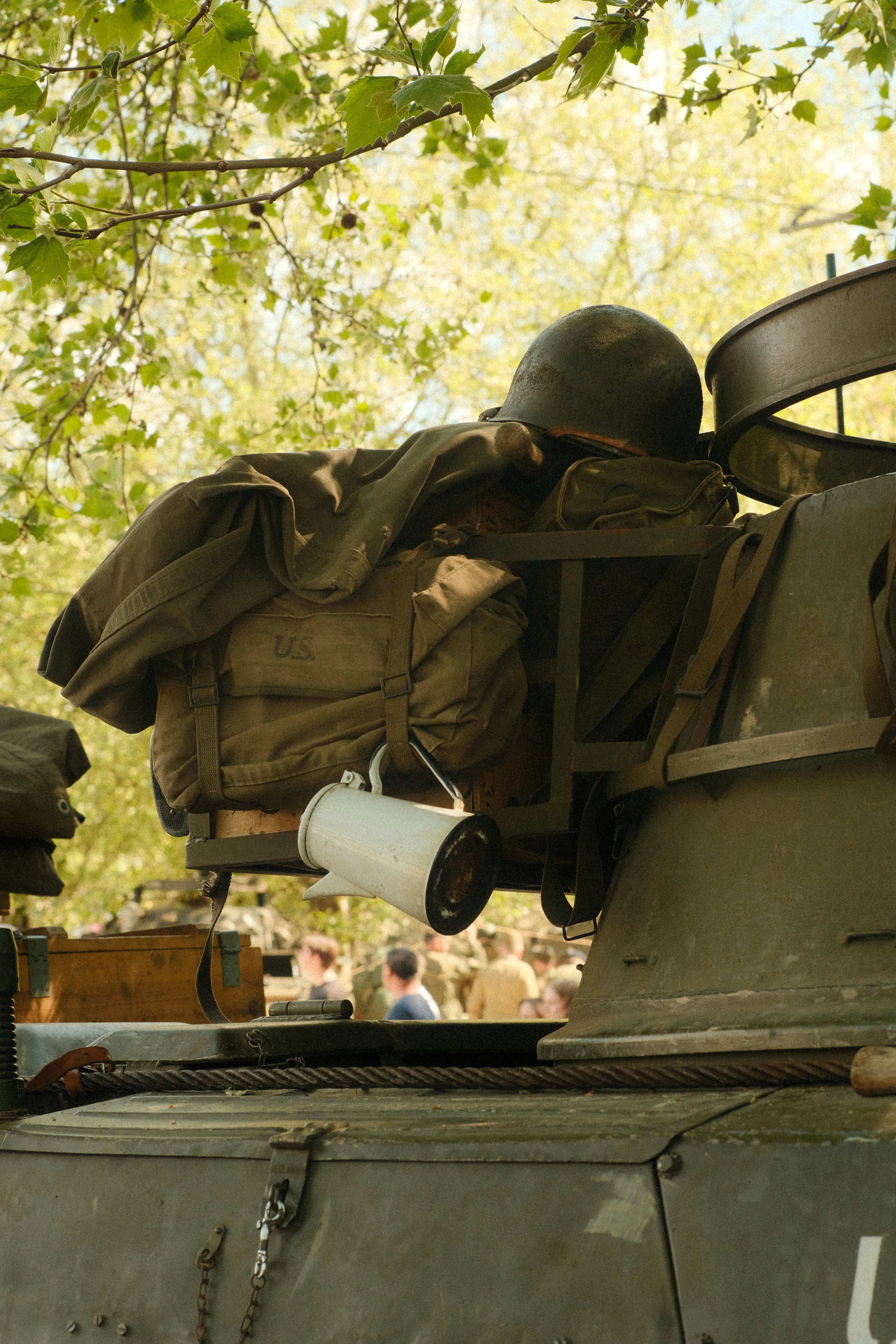 Military gear sits atop an army vehicle.