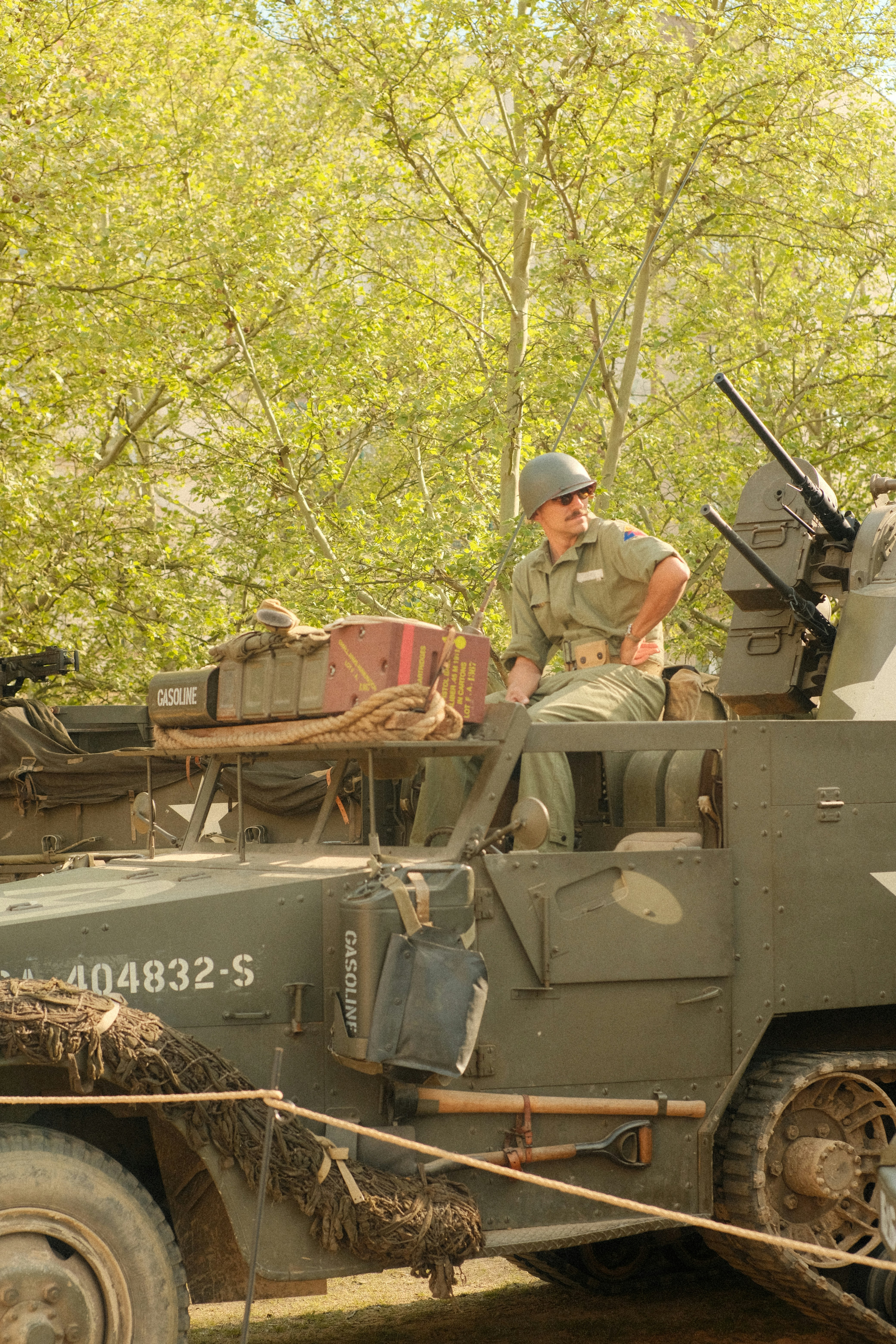 Soldier sits on a military vehicle.