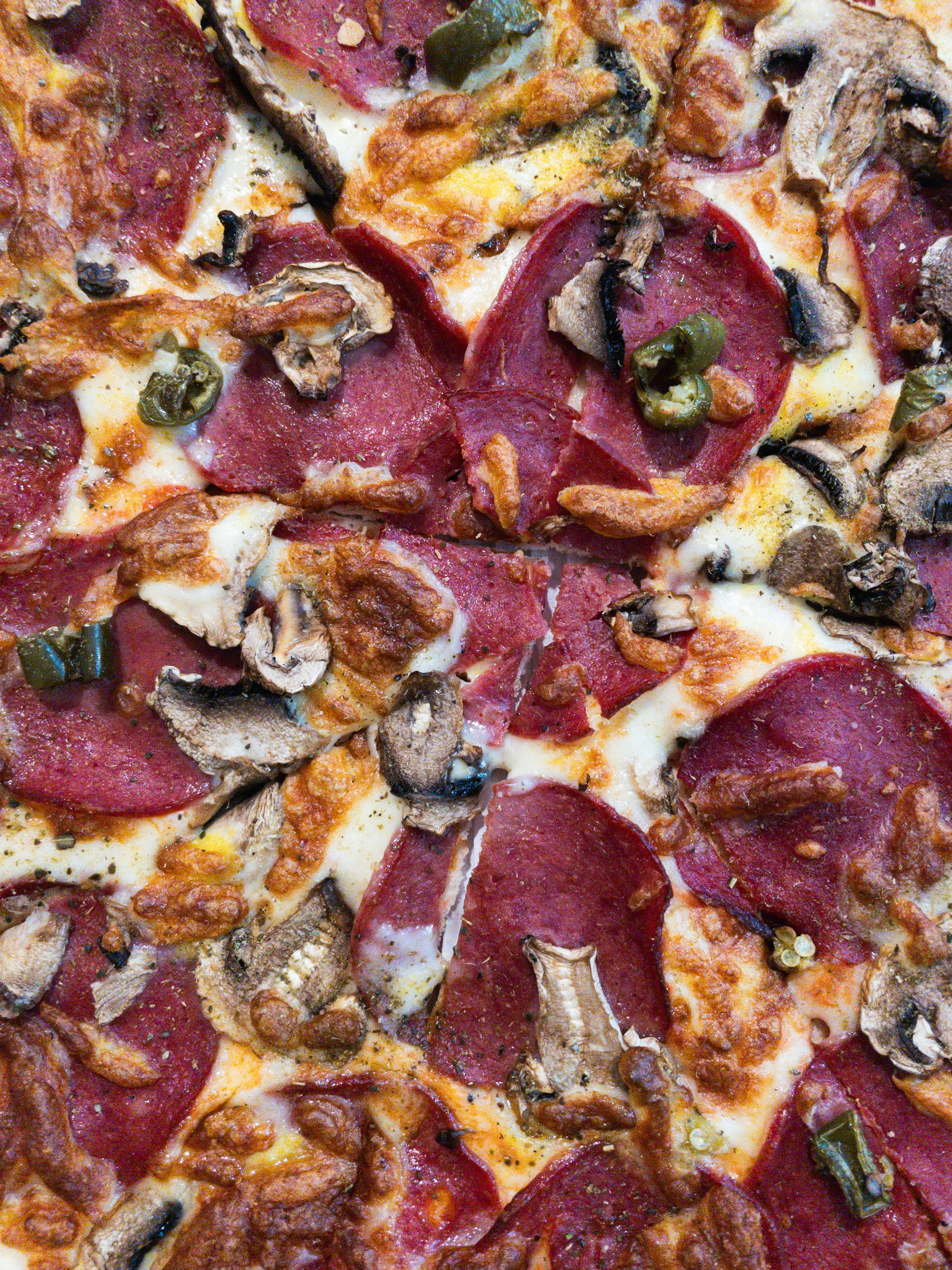 A delicious pizza with pepperoni and mushrooms.