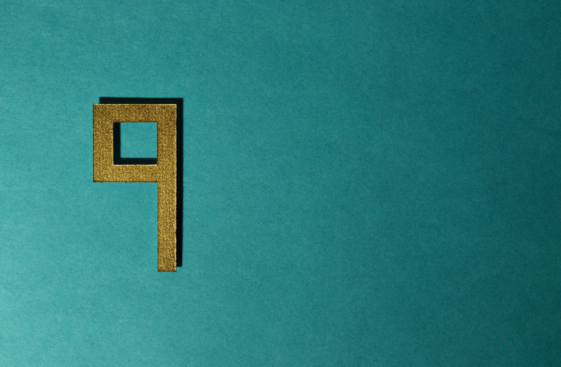 A golden number "9" on a teal background.