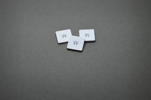 Three tiles with the letter "w" on them.