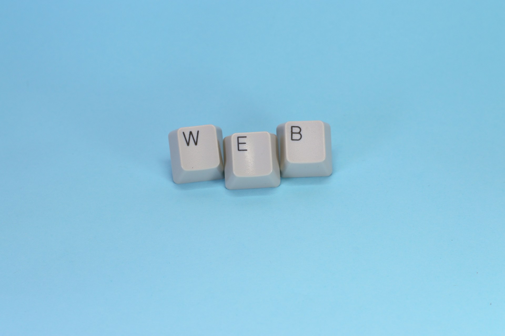 Keyboard keys spell out the word "web."