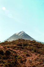 A mountain looms over a hillside