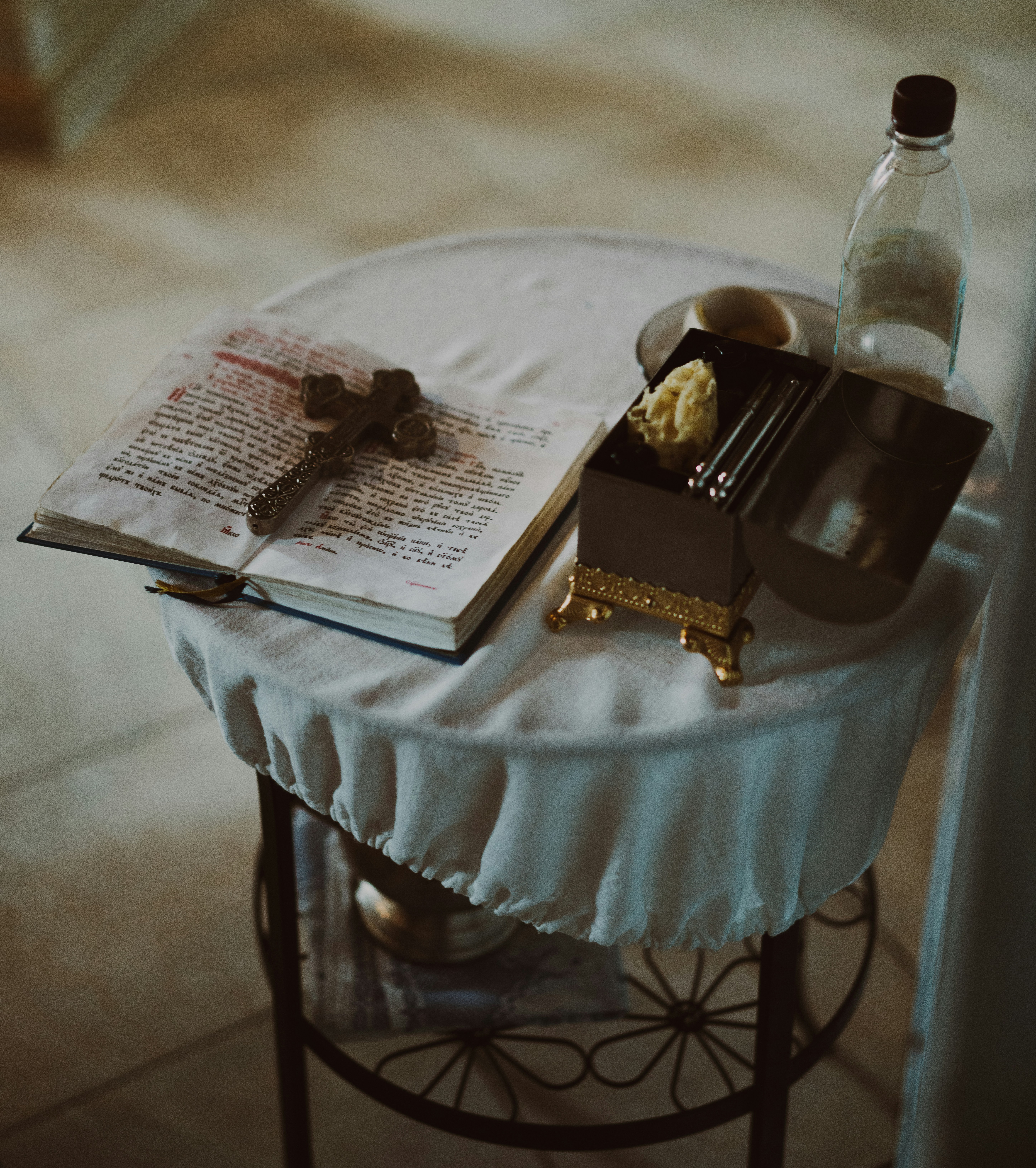 Religious items are arranged on a draped table.