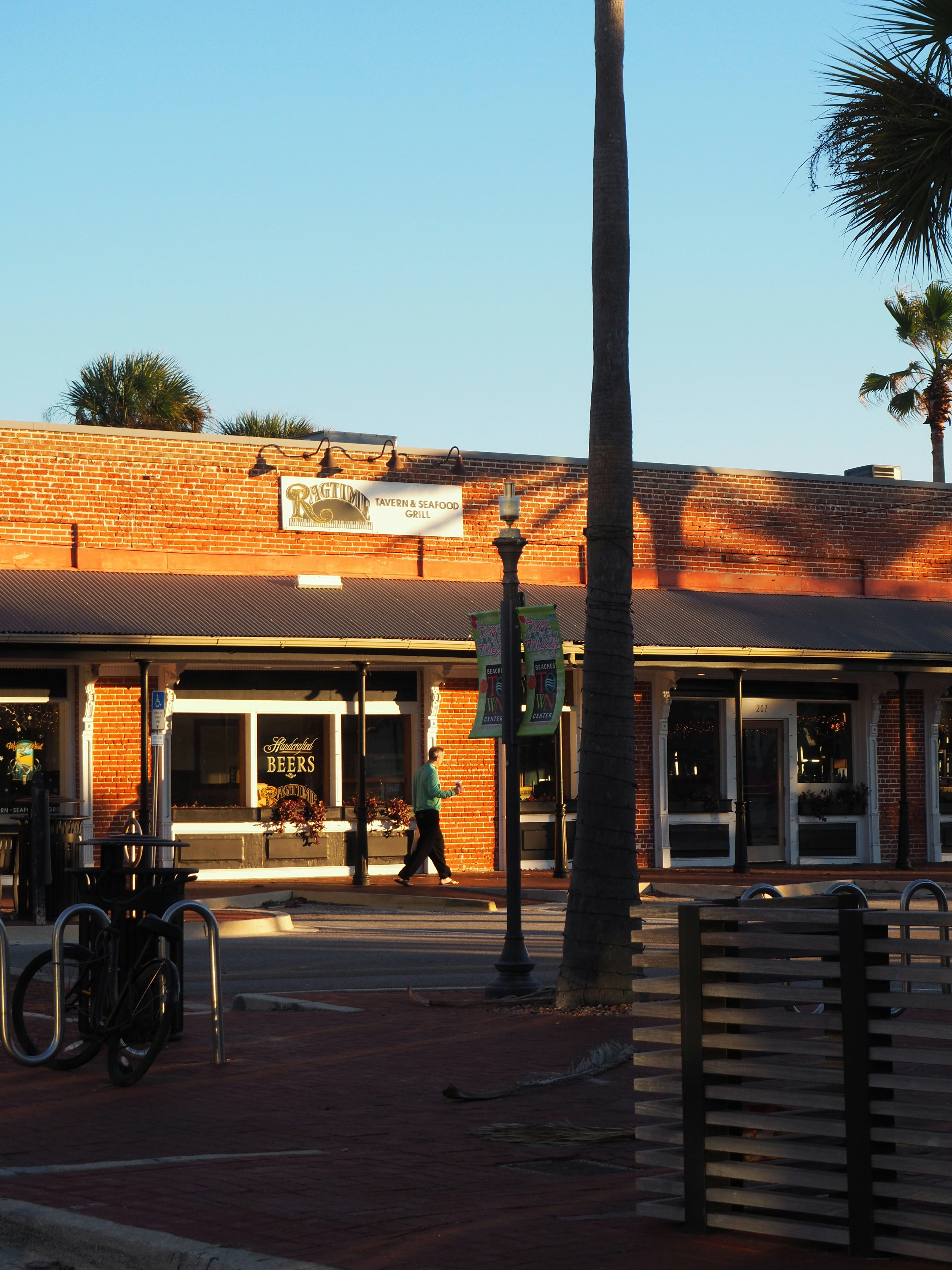 A person walks past a brick building.