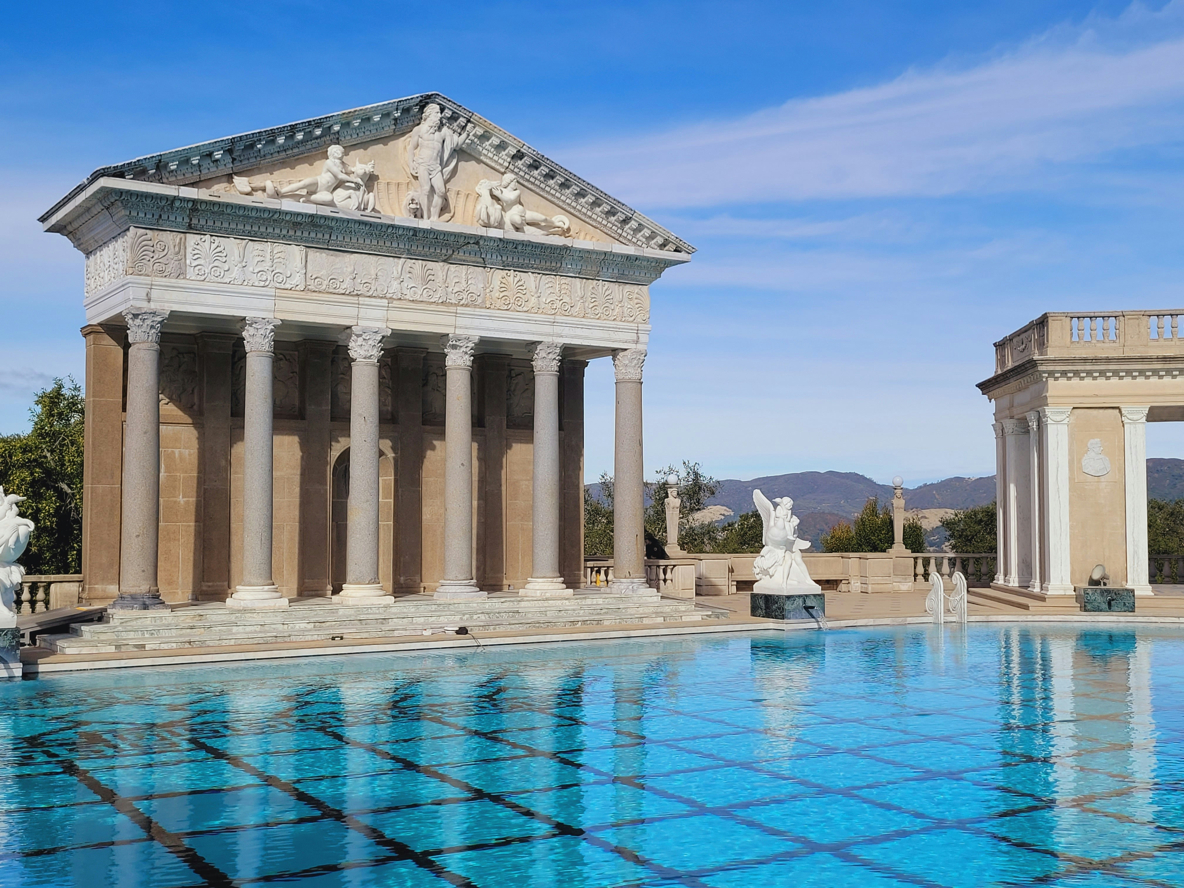 A beautiful pool reflects an elegant classical building.