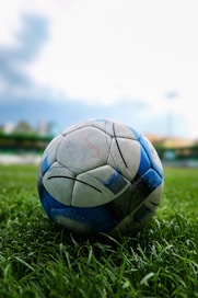 A soccer ball rests on the field's grass.