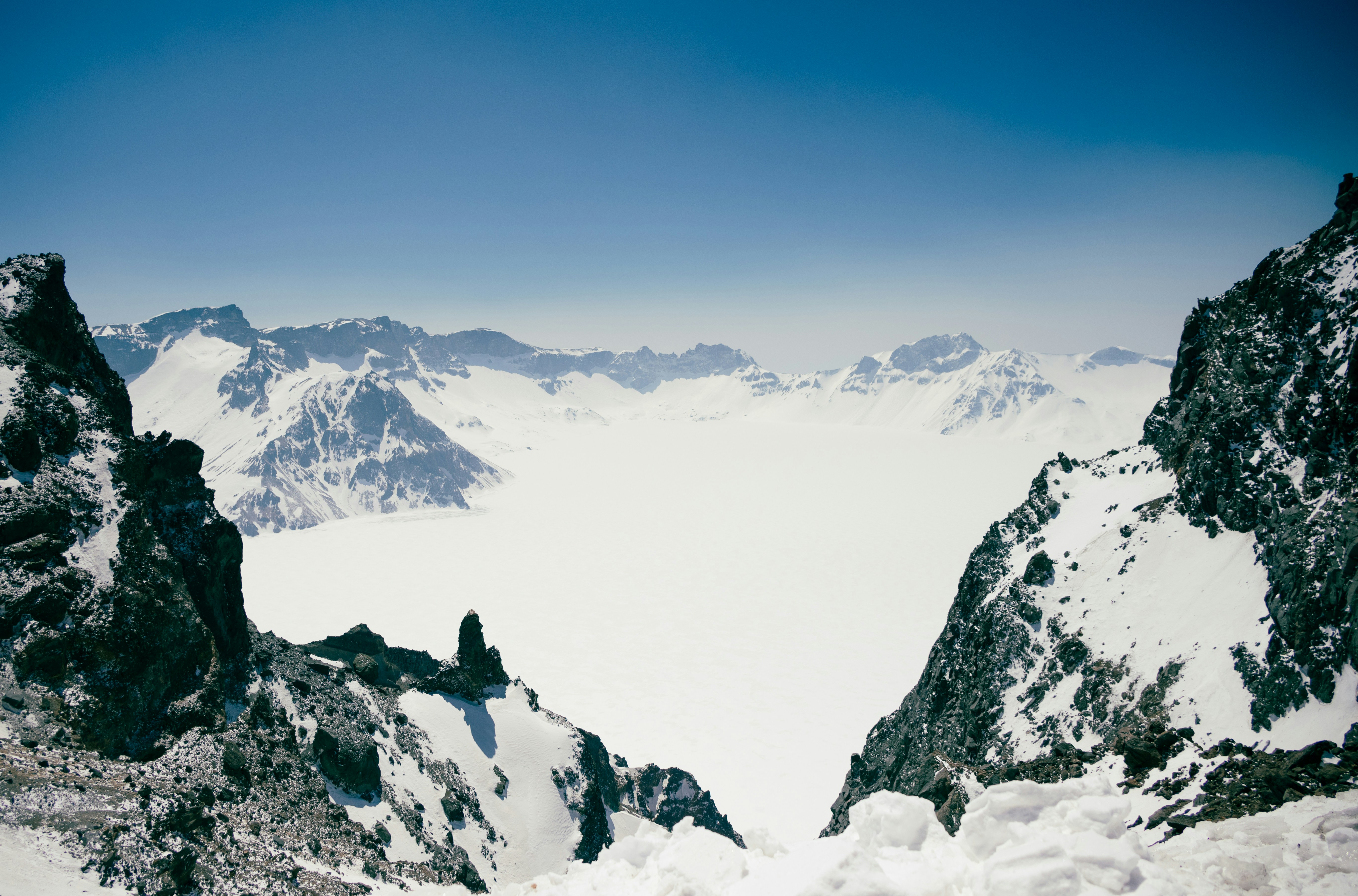 Snowy mountains are seen from above.