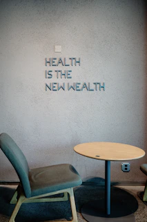 Health is the new wealth, shown near a chair.