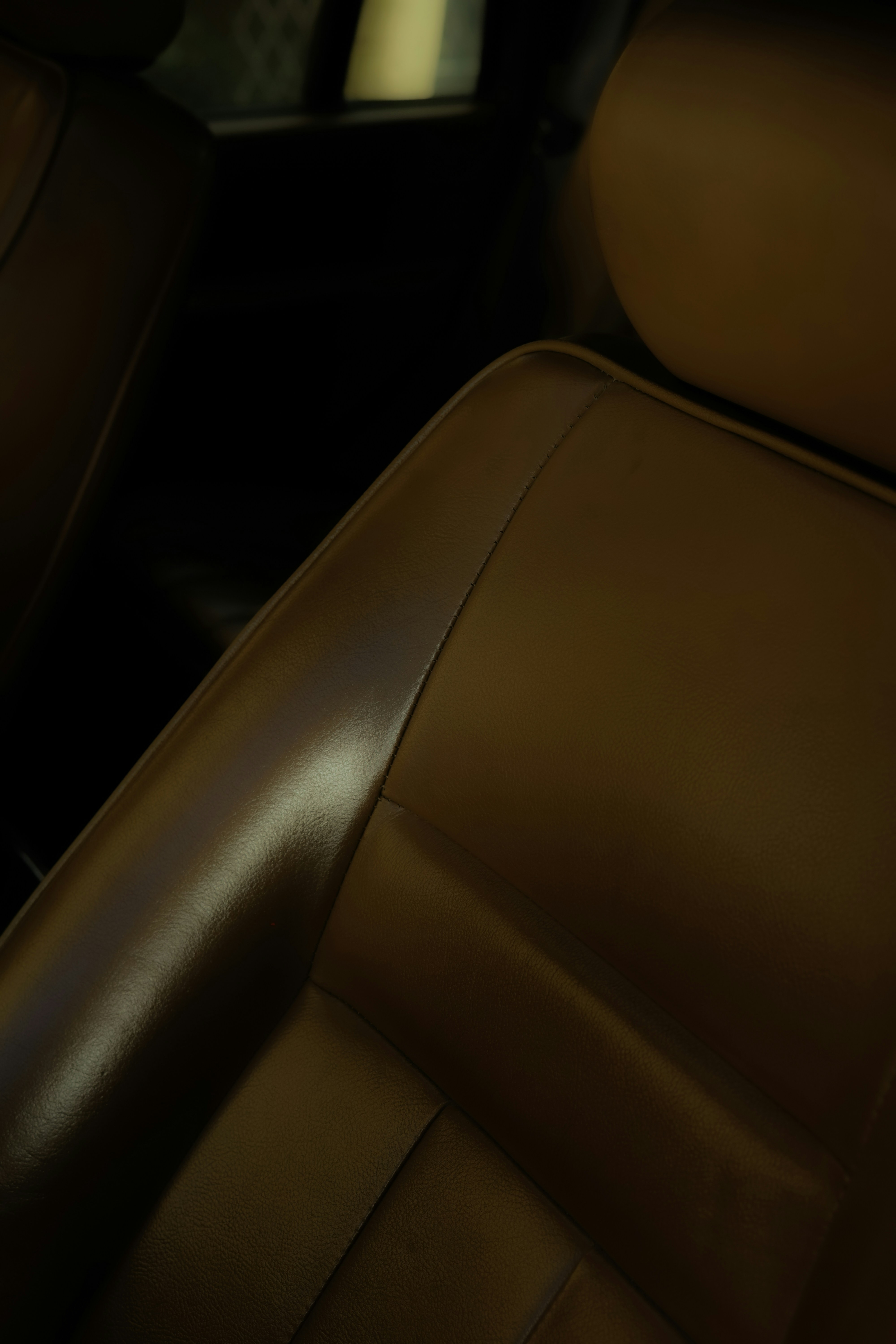 Interior of a luxury car with leather seats and amenities