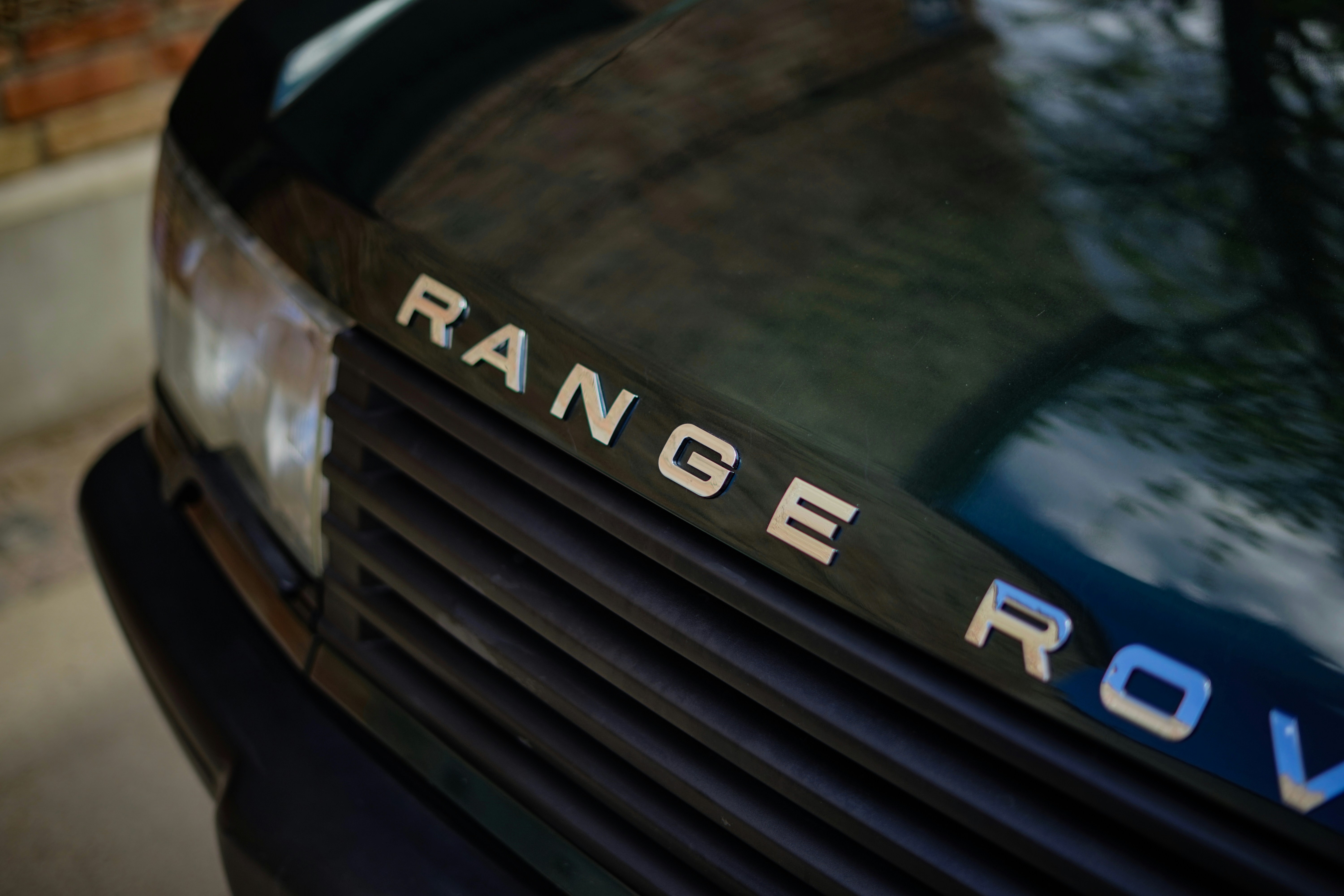 Range Rover Sport plug-in hybrid parked and charging on a home wallbox