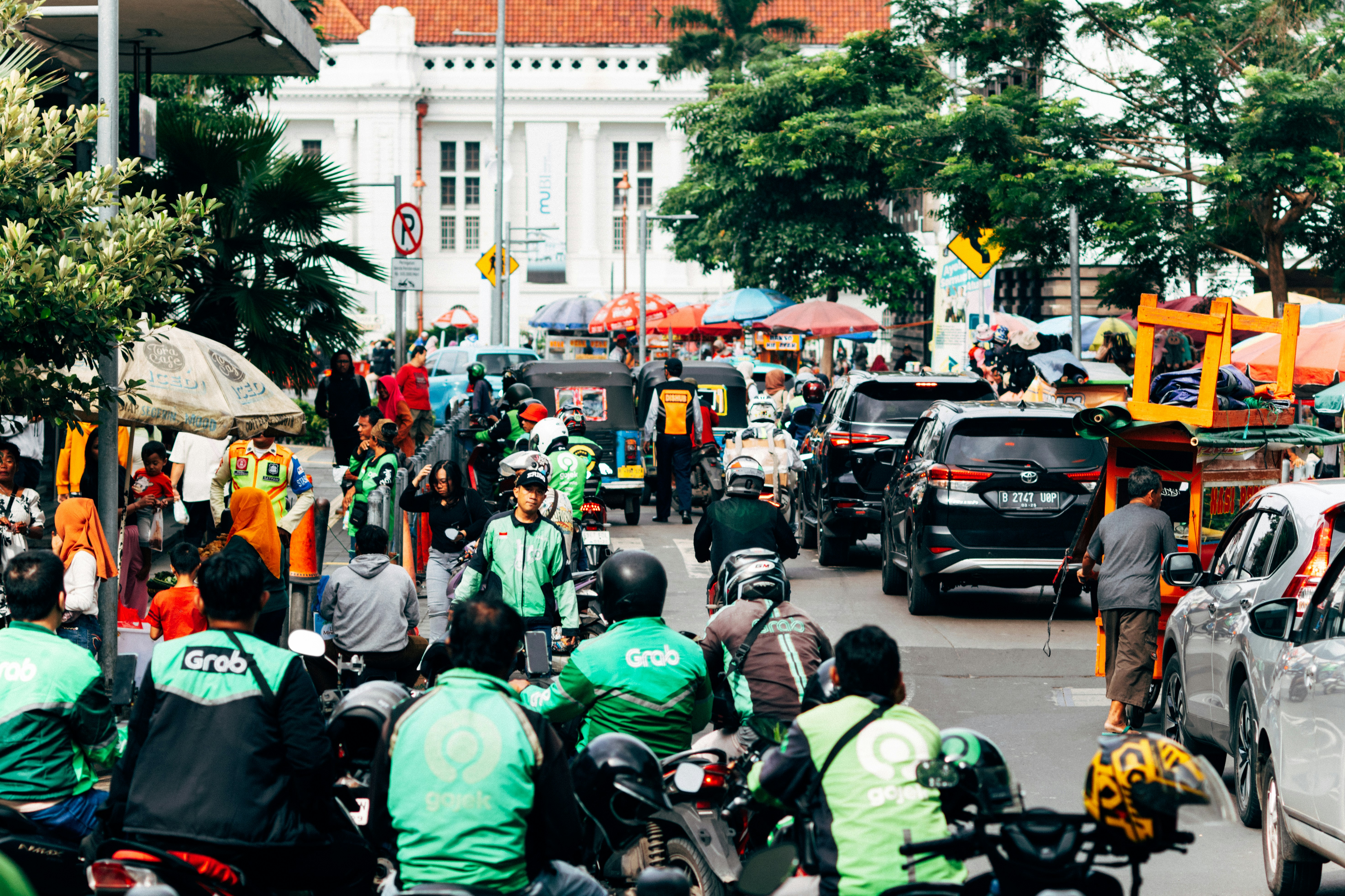 Busy street scene with lots of traffic and people.