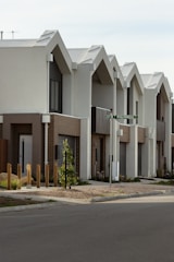 Row of modern houses with interesting roof design.