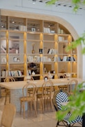 A cozy cafe with wooden furniture and bookshelves.
