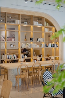 A cozy cafe with wooden furniture and bookshelves.