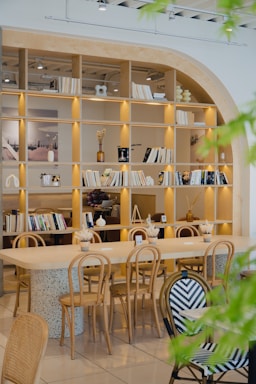 A cozy cafe with wooden furniture and bookshelves.
