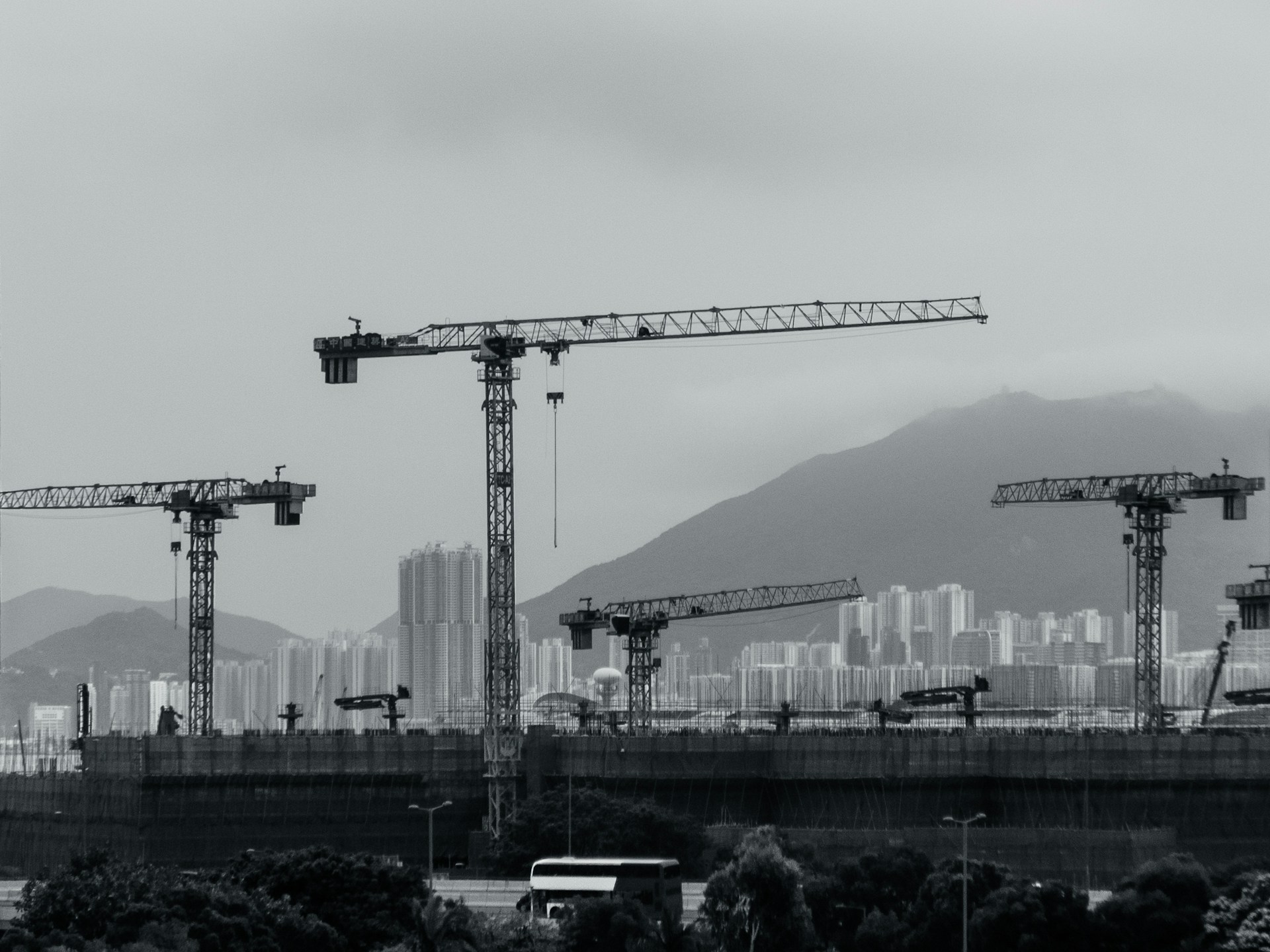 Construction cranes populate the cityscape.