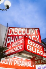 Discount pharmacy sign illuminated at dusk.