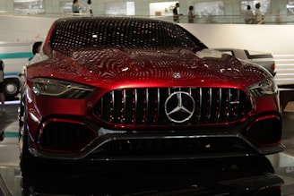 A red mercedes-benz sits on display.