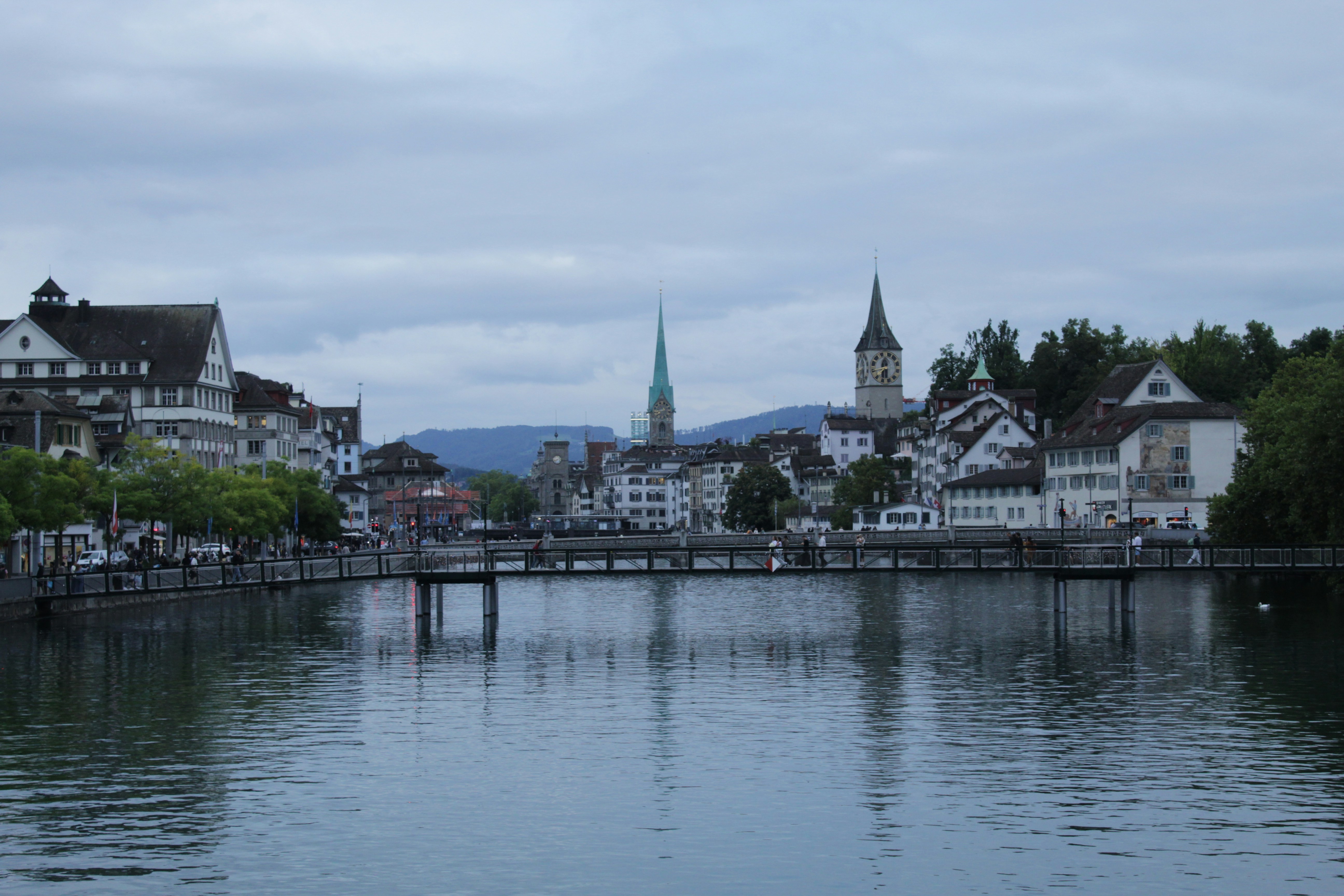 European city buildings reflected in a river at dusk