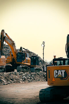 Yellow construction equipment and rubble are visible.