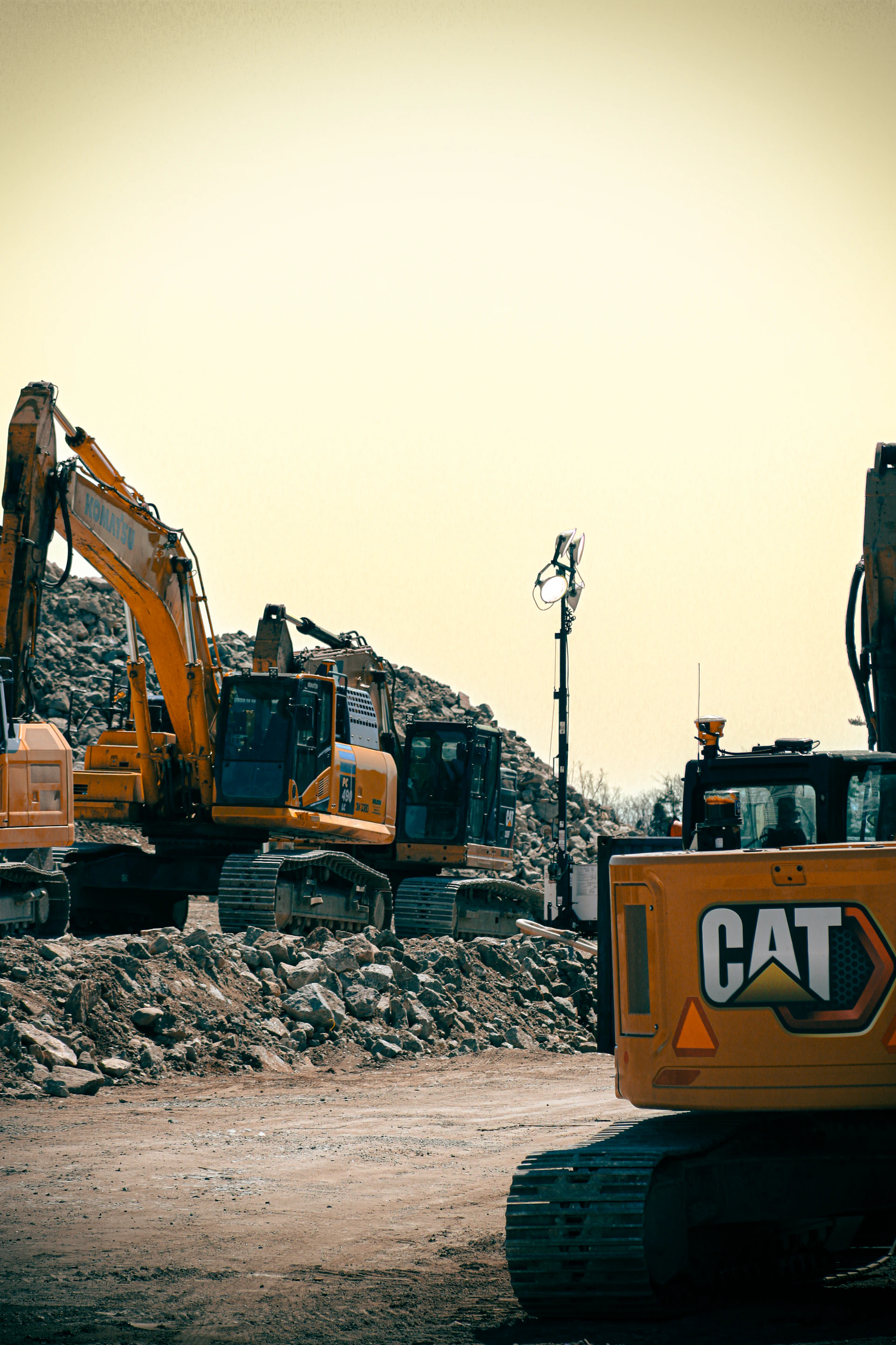 Yellow construction equipment and rubble are visible