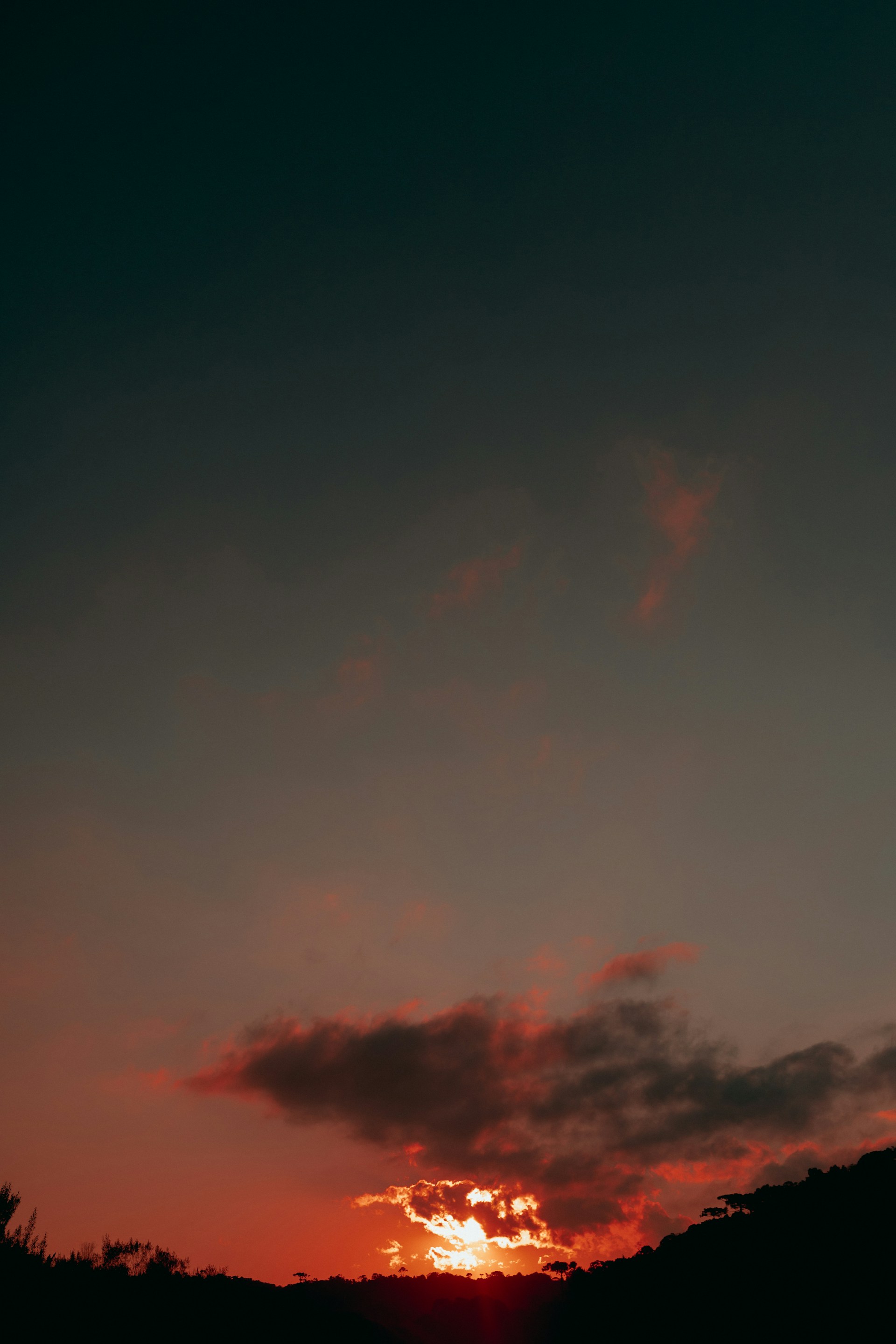 Sunset paints the clouds a fiery orange.