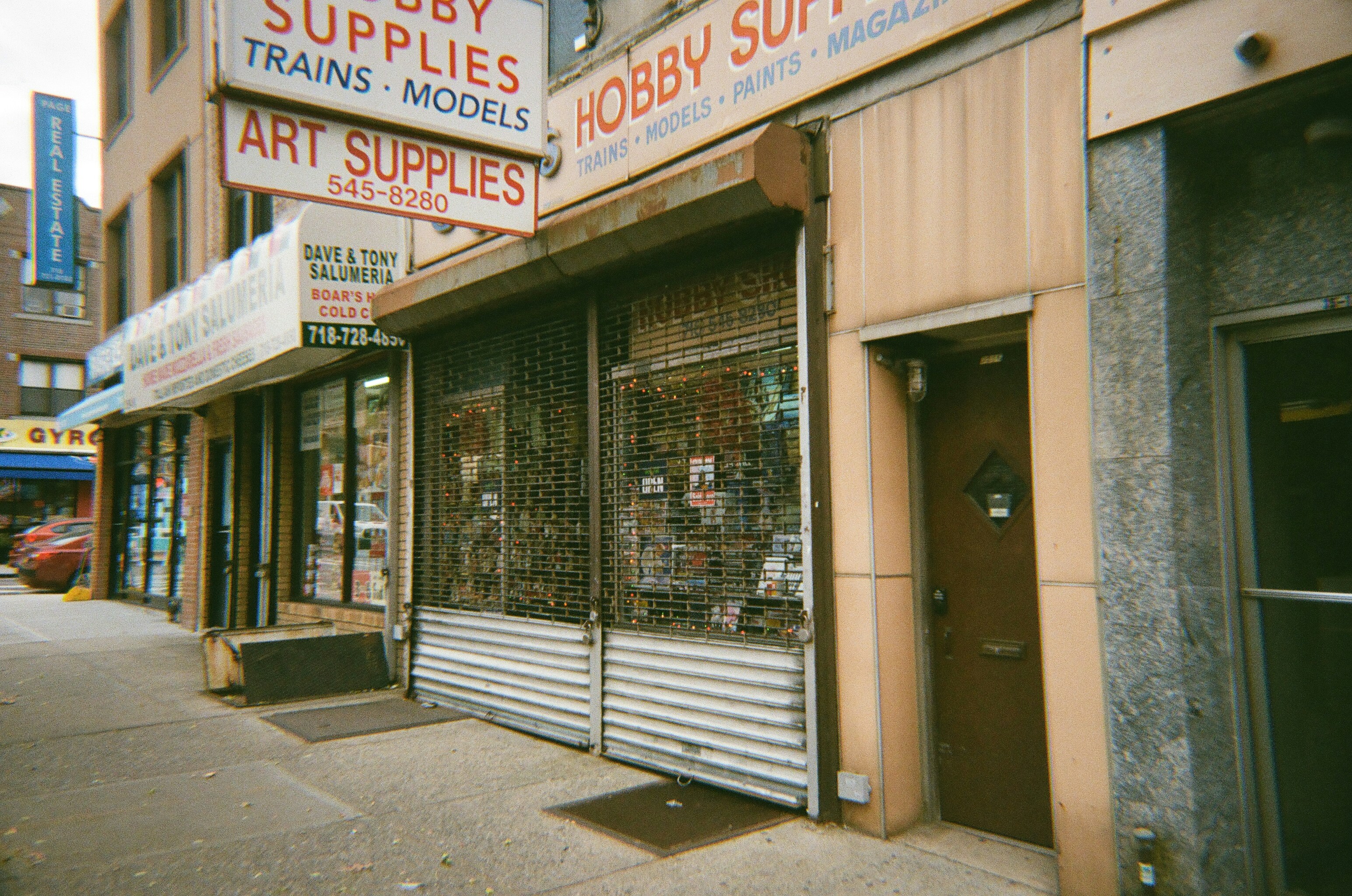 An old hobby supply store is shown on the street.