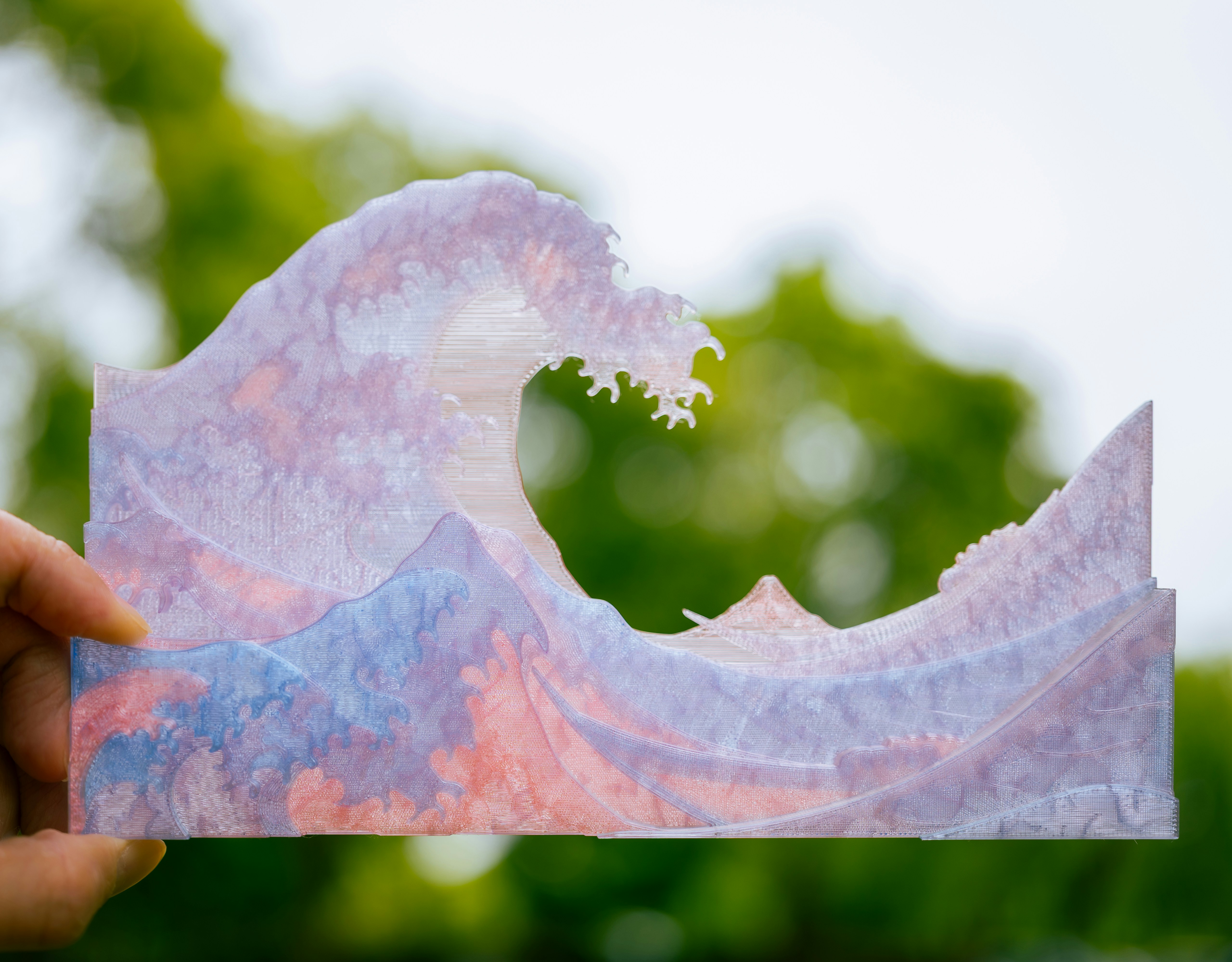 A hand-cut paper wave with vibrant colors.