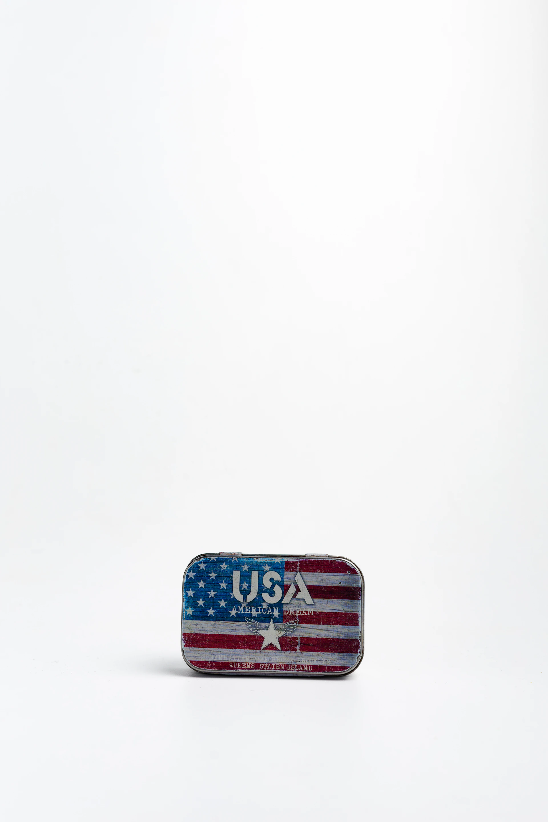 An american flag design on a small tin.