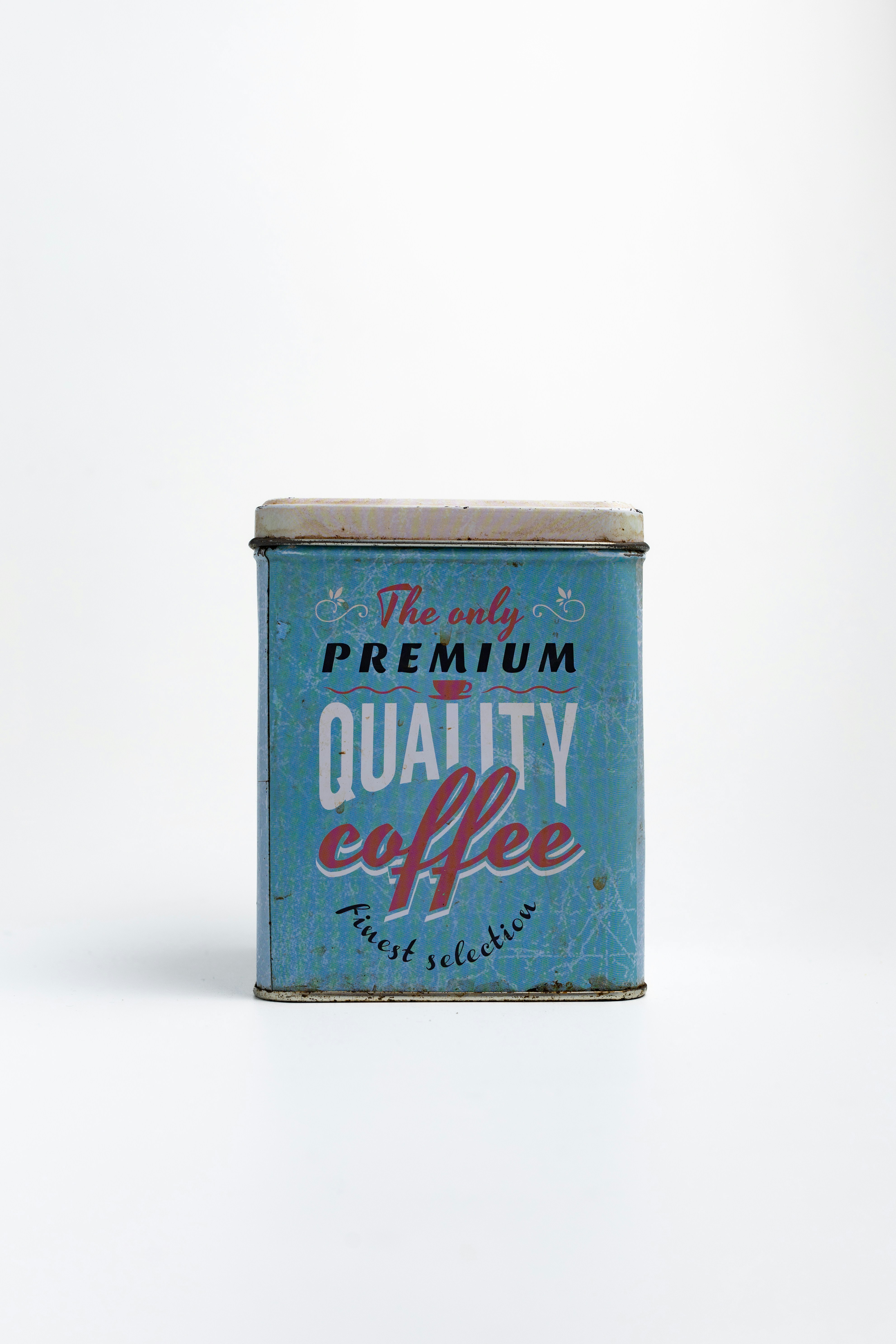 A vintage coffee can sits on a white background.