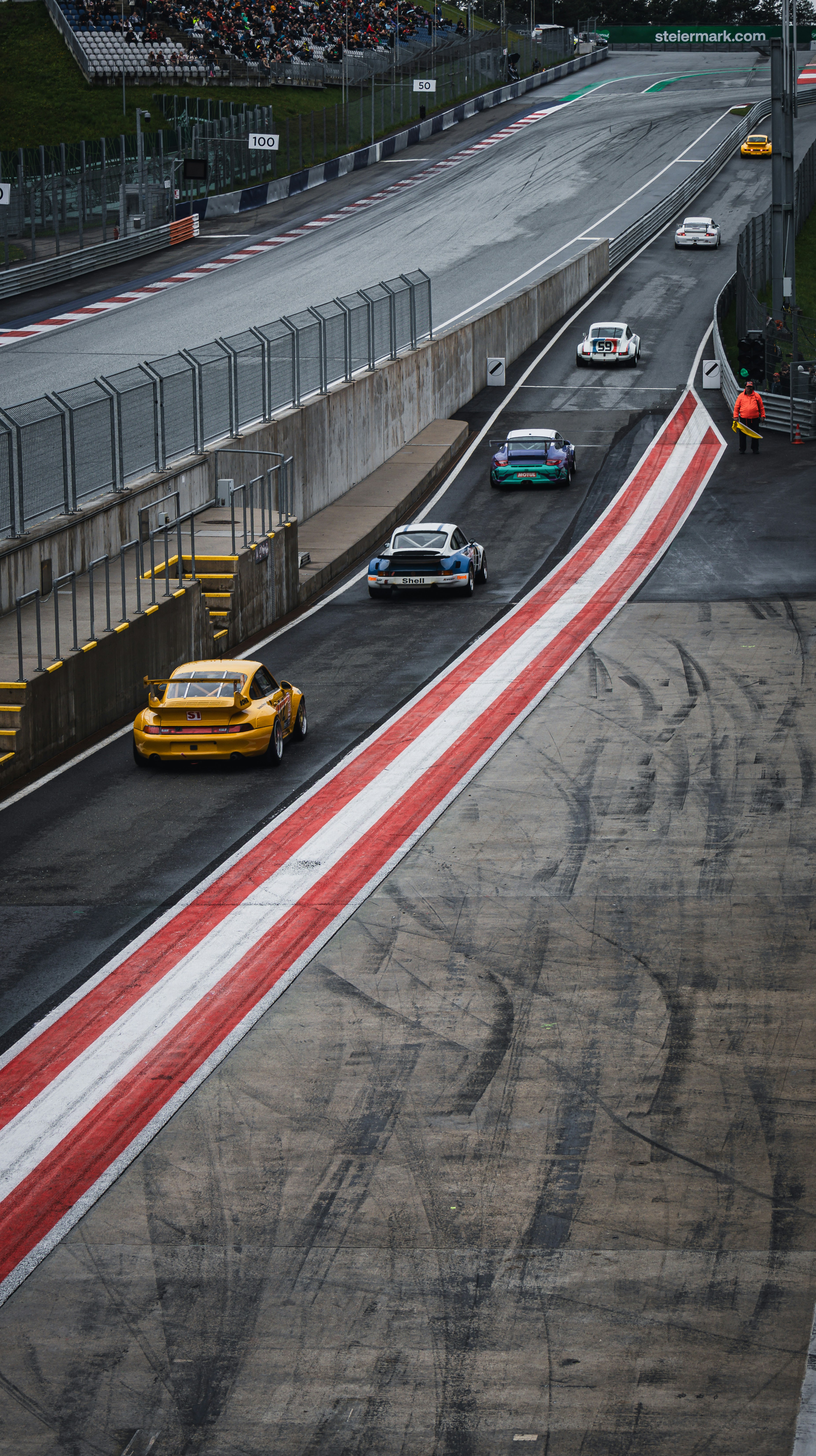 Race cars speed around the track.