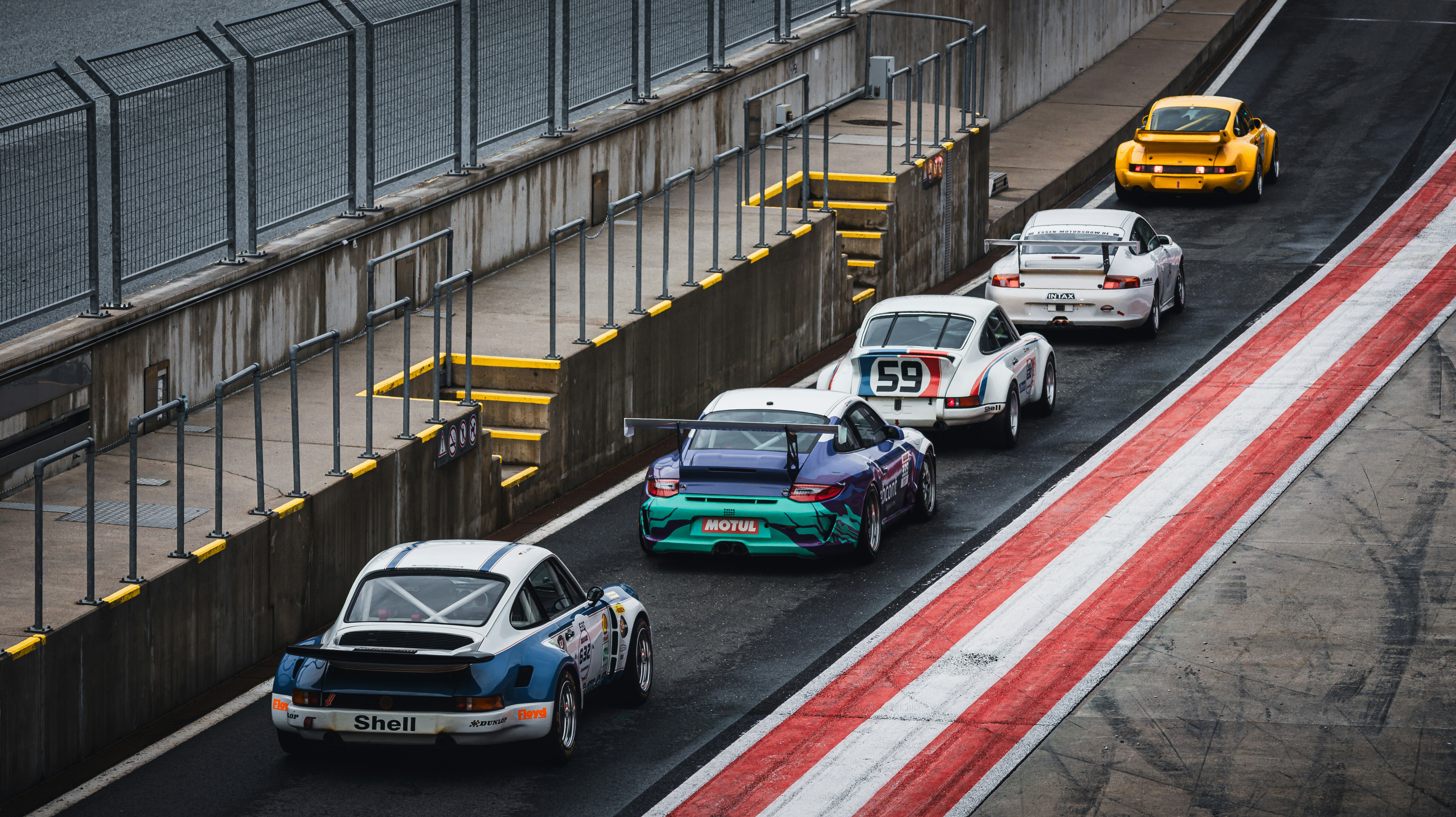 Race cars speeding down the racetrack.