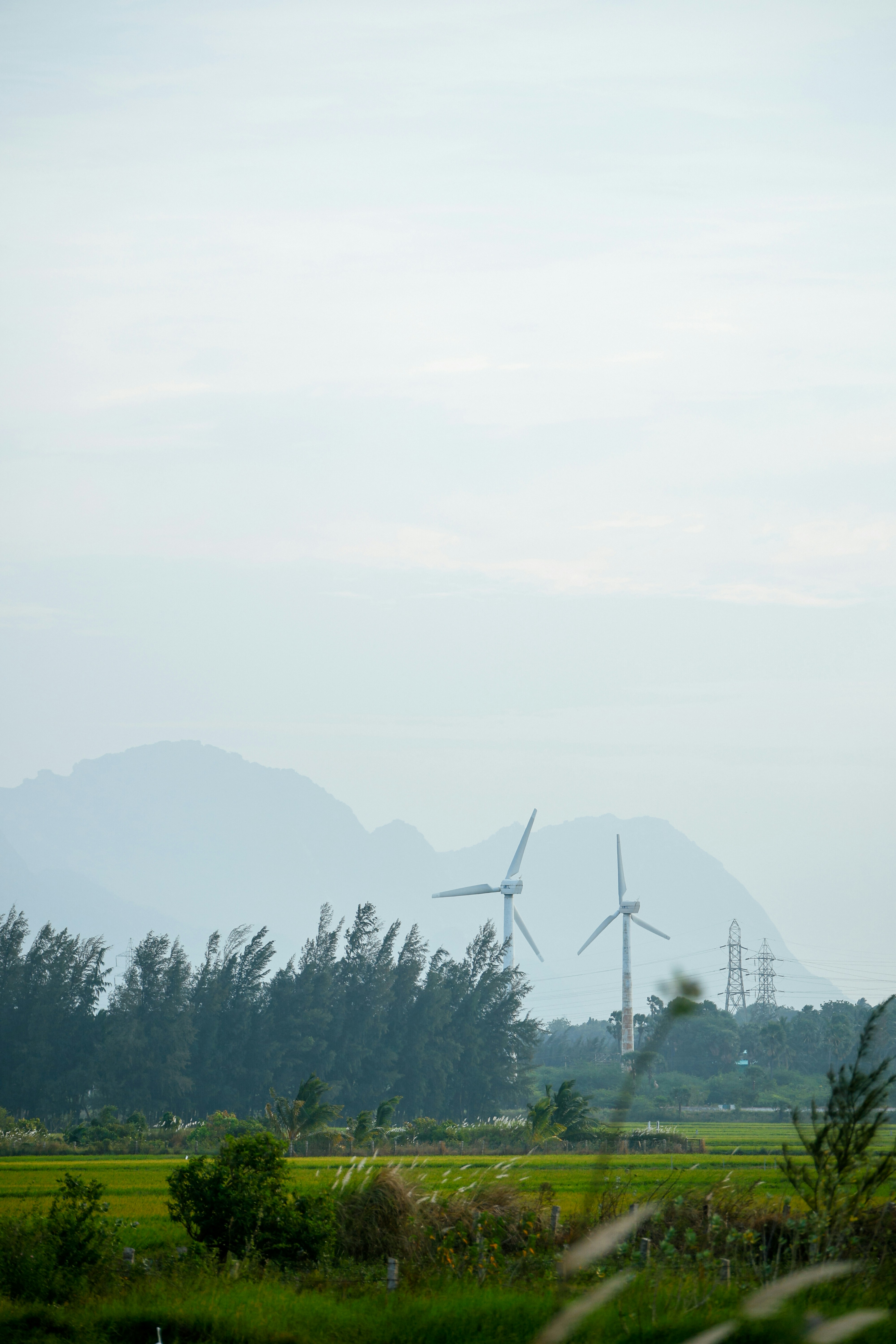 Wind turbines stand tall in a scenic landscape.