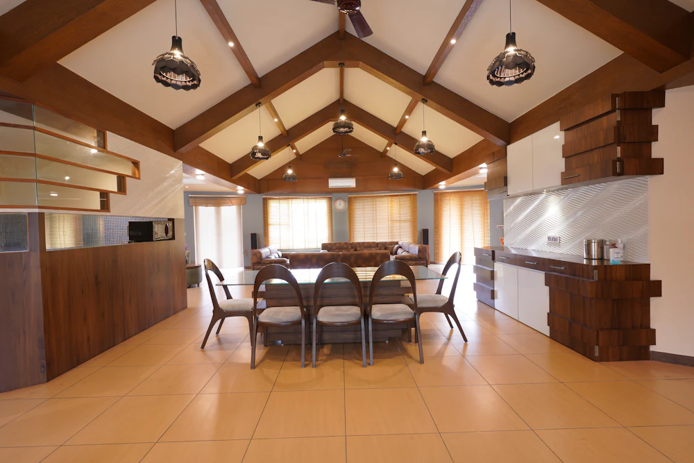A spacious self-catering dining room with wooden beams and long table