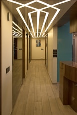 Modern hallway with unique geometric ceiling lighting.