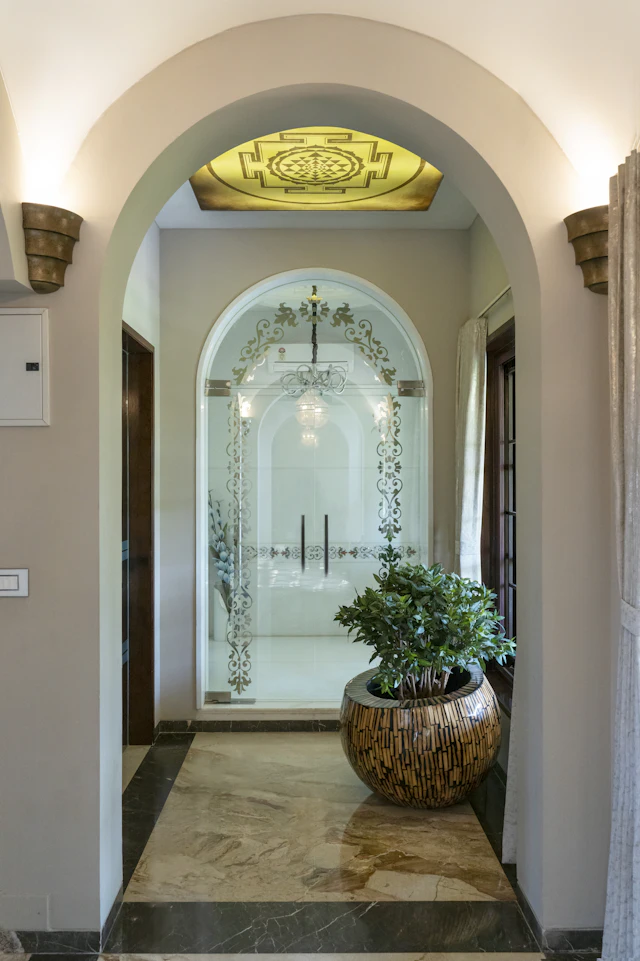 Arched doorway into a hall with a marble floor and a lantern